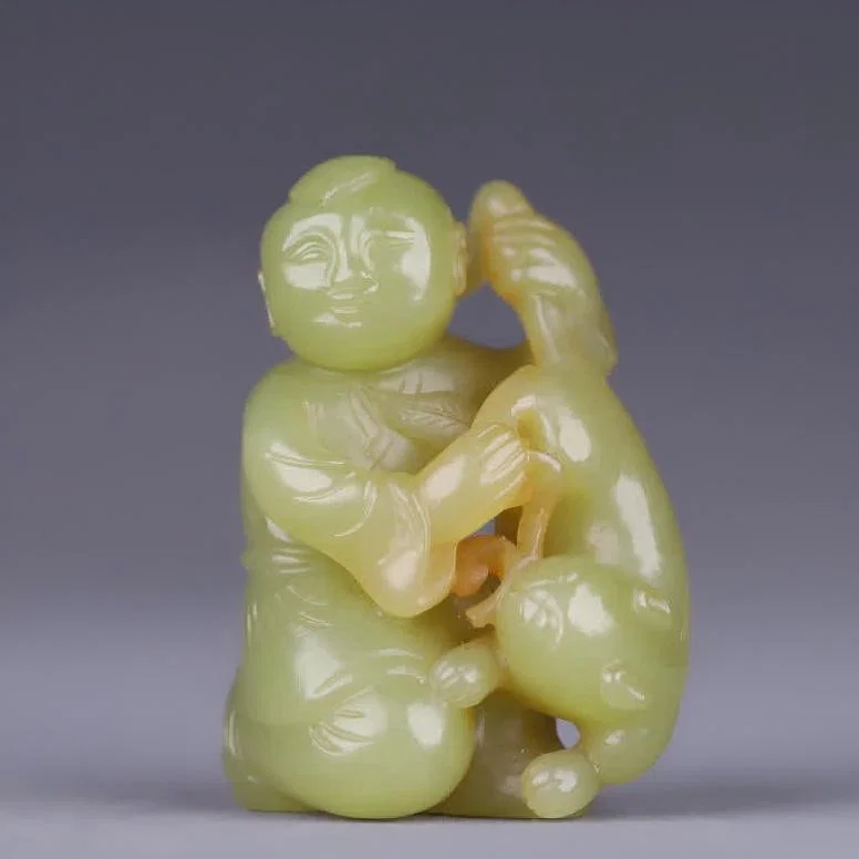 A Qing Dynasty Hetian topaz boy auspicious beast carving