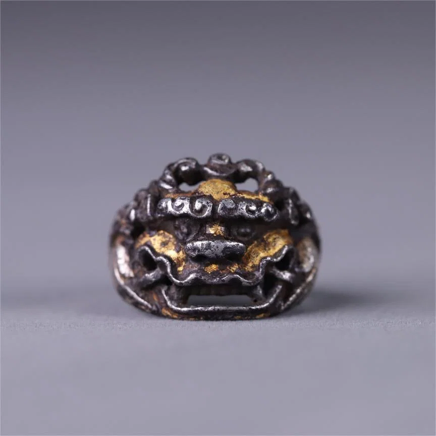A Qing Dynasty iron-cut gold lion-faced ring with a living mouth