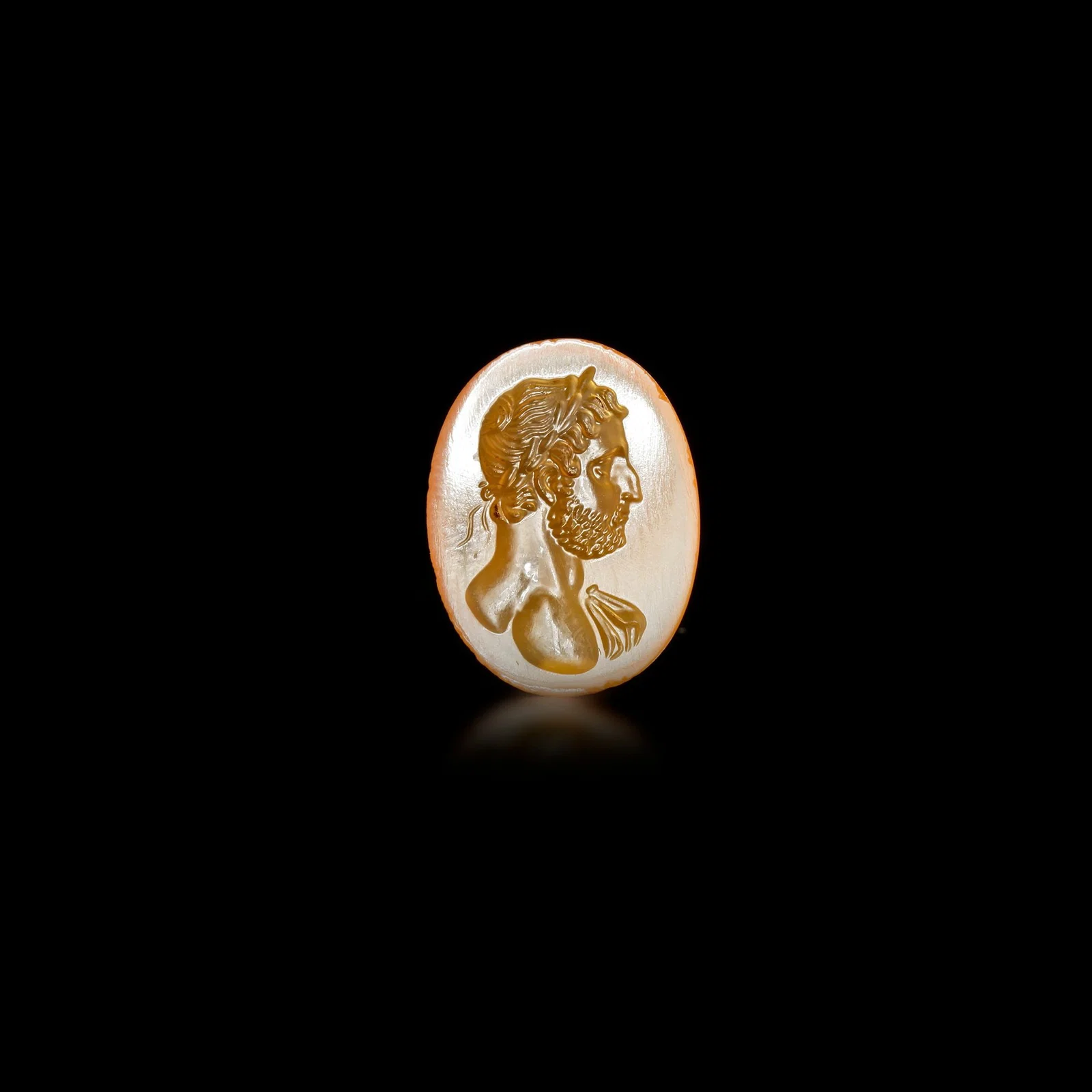 A RADIANT ORANGE AGATE ROMAN INTAGLIO OF EMPEROR HADRIAN â€“ 1ST TO 2ND CENTURY A.D.