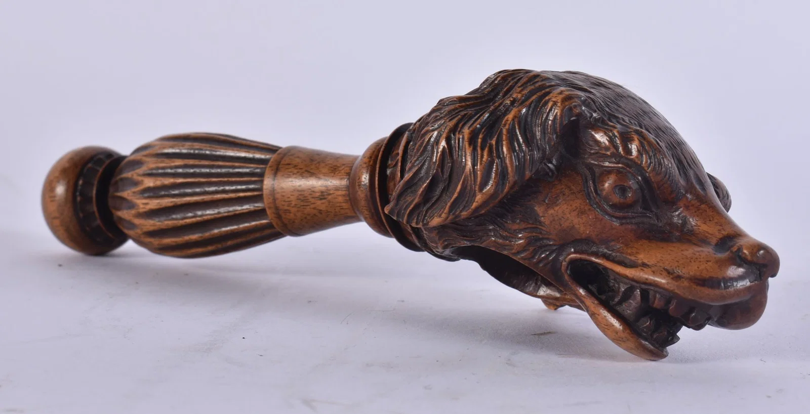 A RARE 19TH CENTURY BAVARIAN TREEN CARVED WOOD NUT CRACKER formed as a scowling hound. 18.5 cm wide.