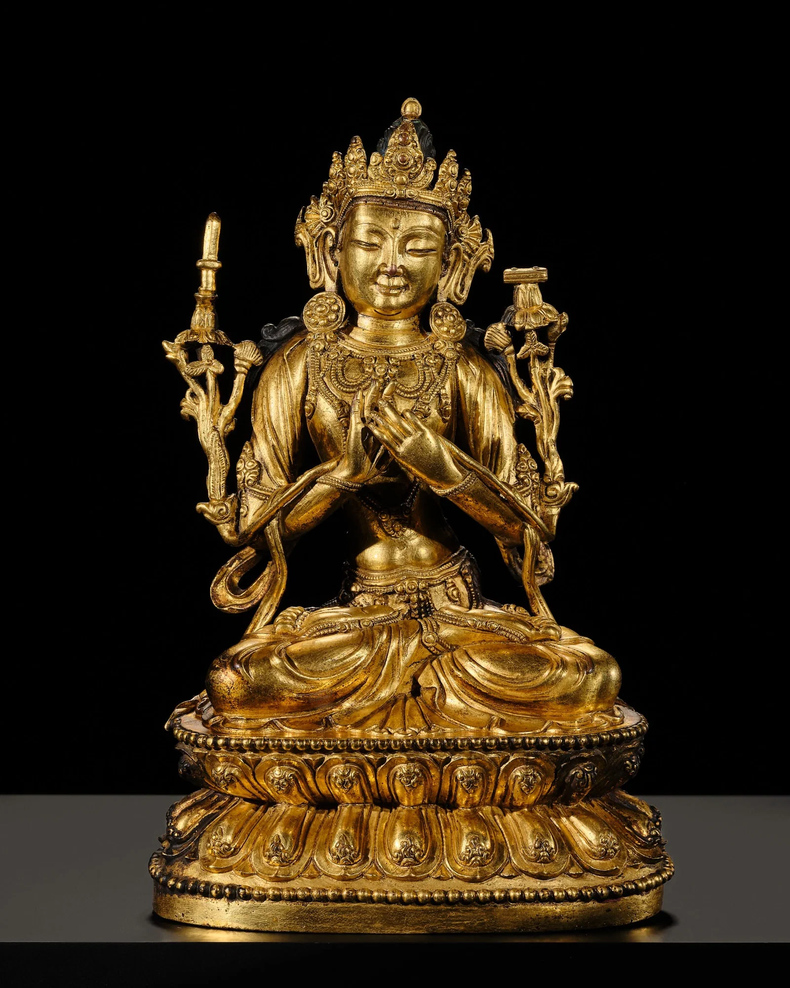 A RARE AND FINELY CAST GILT-BRONZE FIGURE OF MANJUSRI, MING DYNASTY, YONGLE TO XUANDE PERIOD