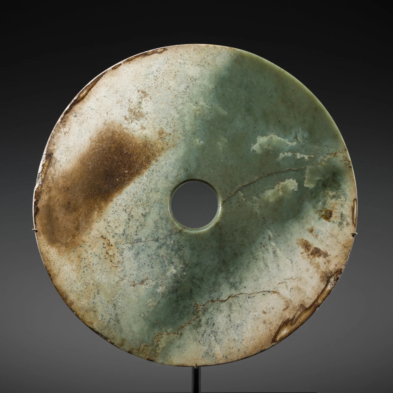 A RARE AND LARGE (33 CM) GREEN JADE DISK, BI, EARLY BRONZE AGE, QIJIA CULTURE