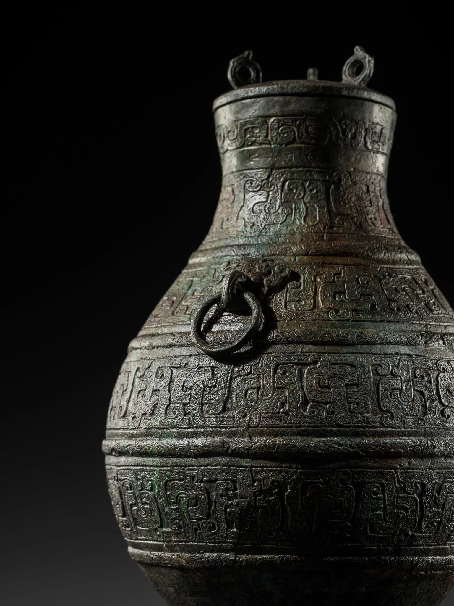 A RARE BRONZE RITUAL WINE VESSEL AND COVER, HU, WARRING STATES PERIOD, WITH TWO INSCRIPTIONS