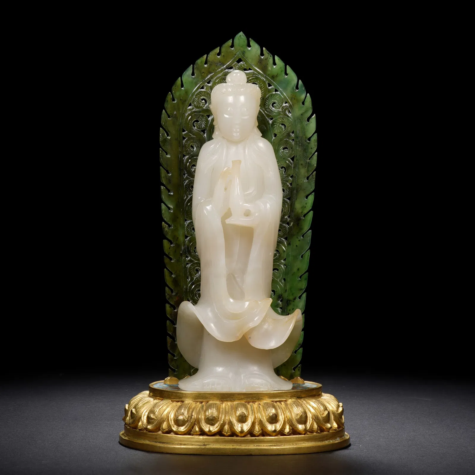 A RARE CARVED WHITE JADE STANDING GUANYIN