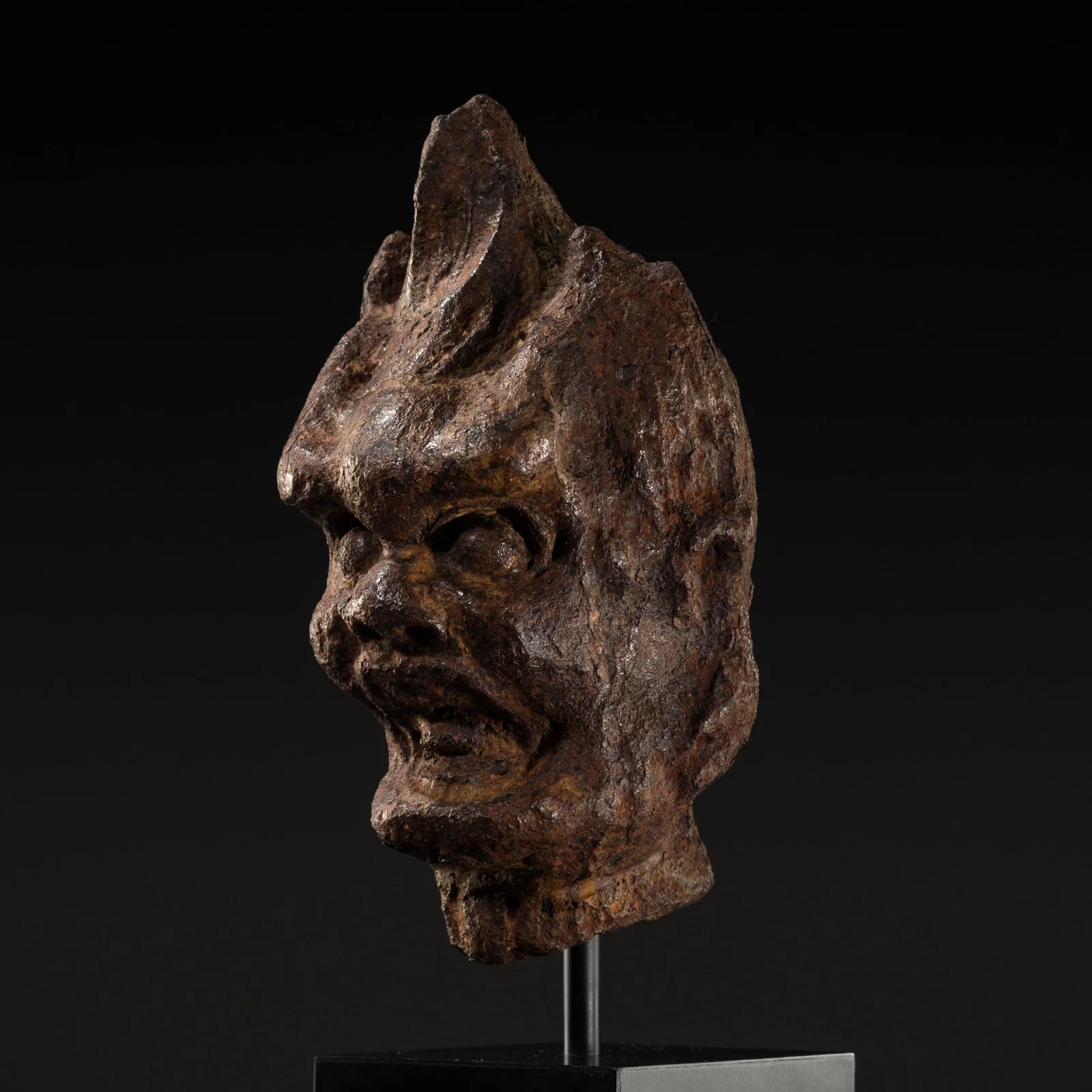 A RARE CAST IRON HEAD OF A LOKAPALA, TANG DYNASTY