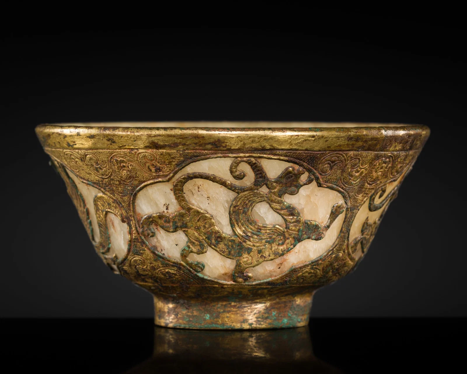 A RARE 'FOUR GUARDIANS' GILT-COPPER REPOUSSÉ AND MARBLE BOWL, LIAO DYNASTY