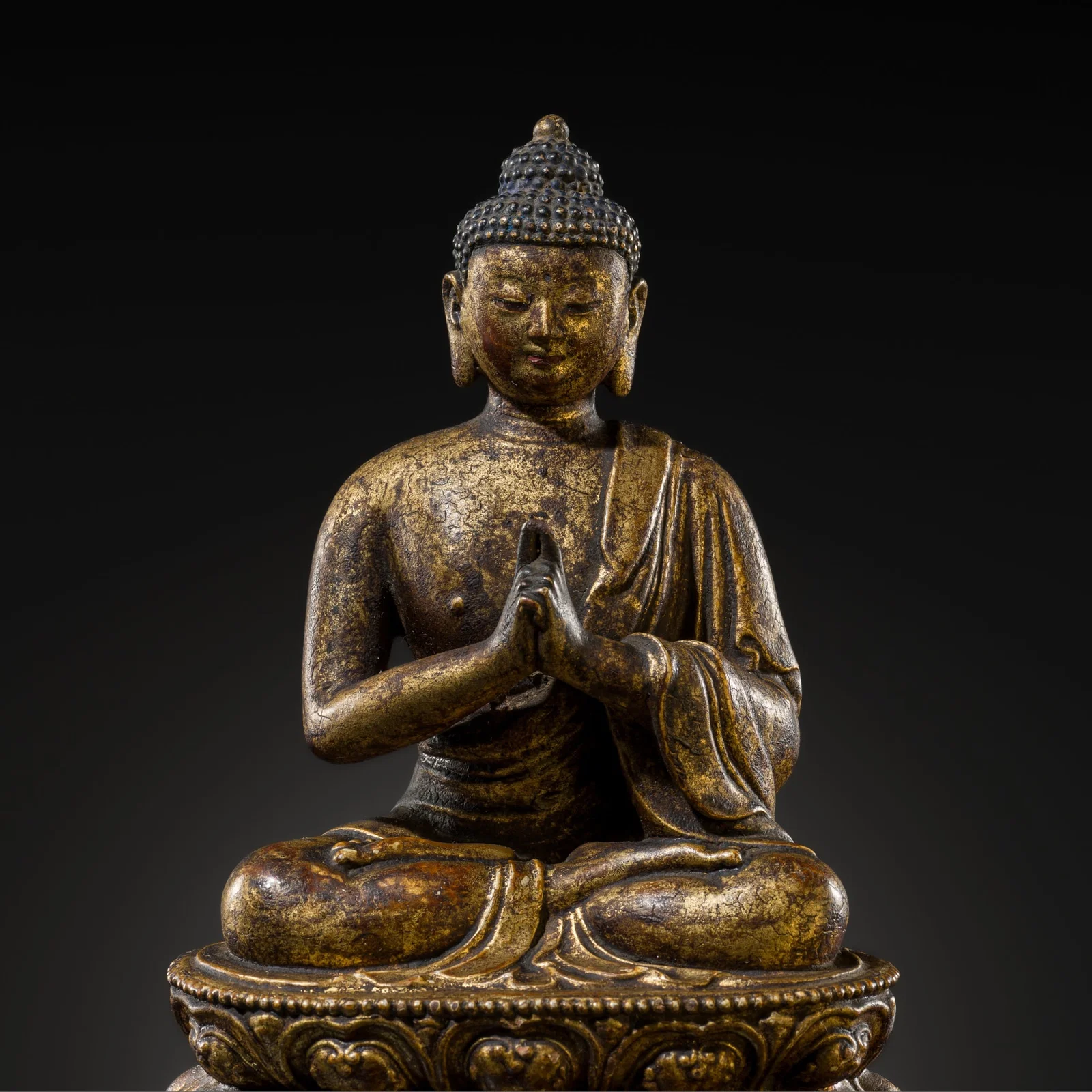 A RARE GILT-LACQUERED CLAY FIGURE OF BUDDHA VAIROCANA, MING DYNASTY