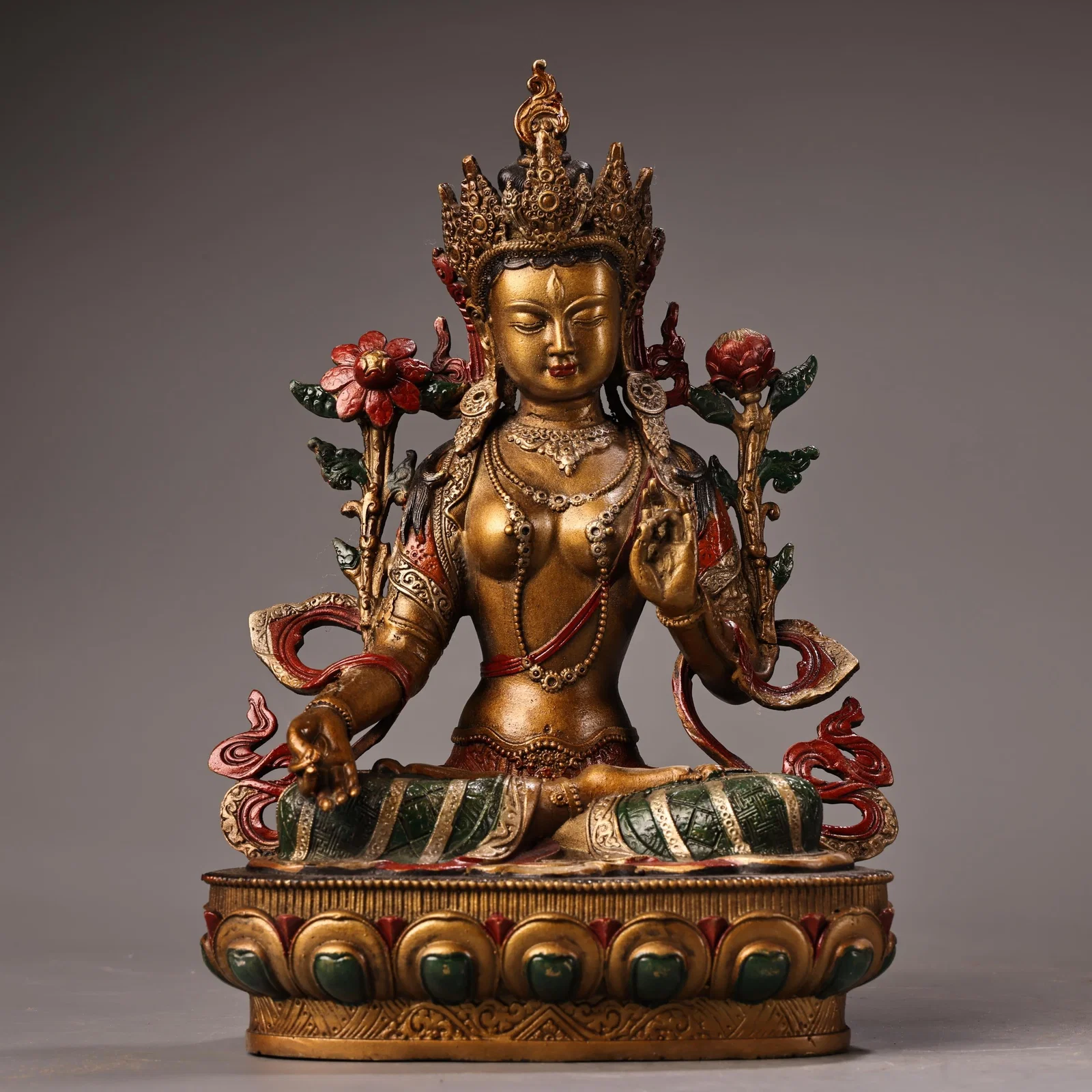 A rare, high-relief, painted, and gilded Tibetan White Tara Buddha statue from a private collection.