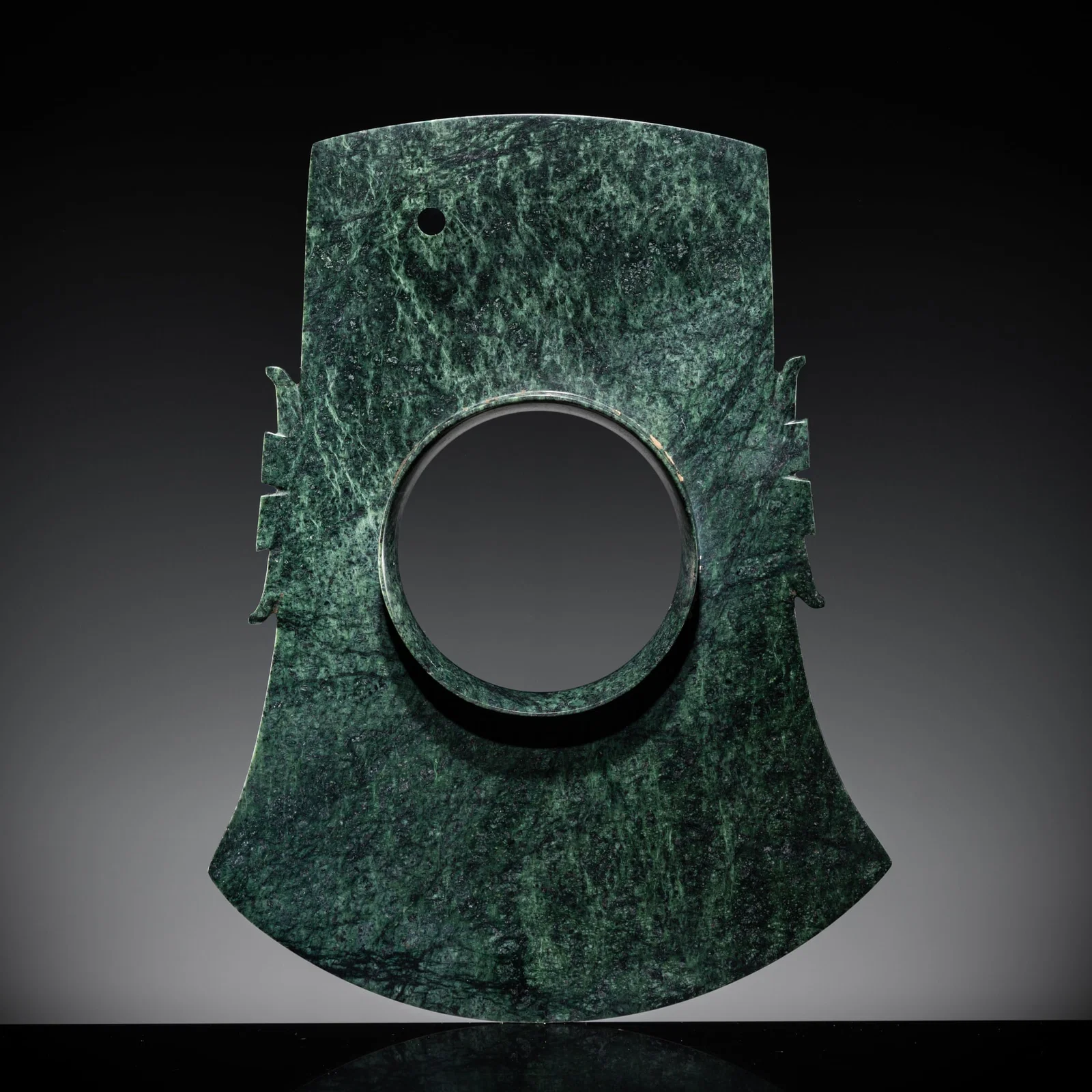 A RARE MOTTLED GREEN JADE COLLARED AXE, YUE, LATE SHANG DYNASTY