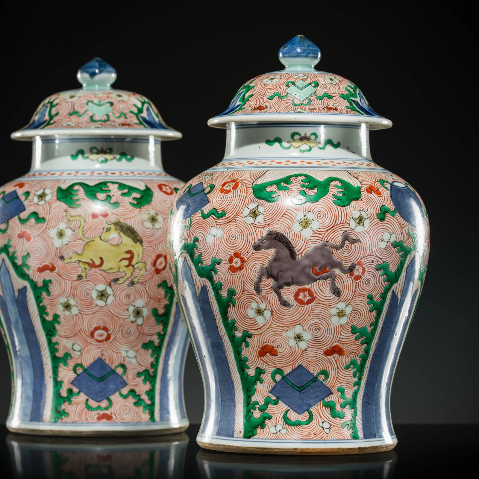 A RARE PAIR OF ABSOLUTELY PERFECT WUCAI 'HEAVENLY HORSES' JARS AND COVERS, LATE KANGXI TO YONGZHENG