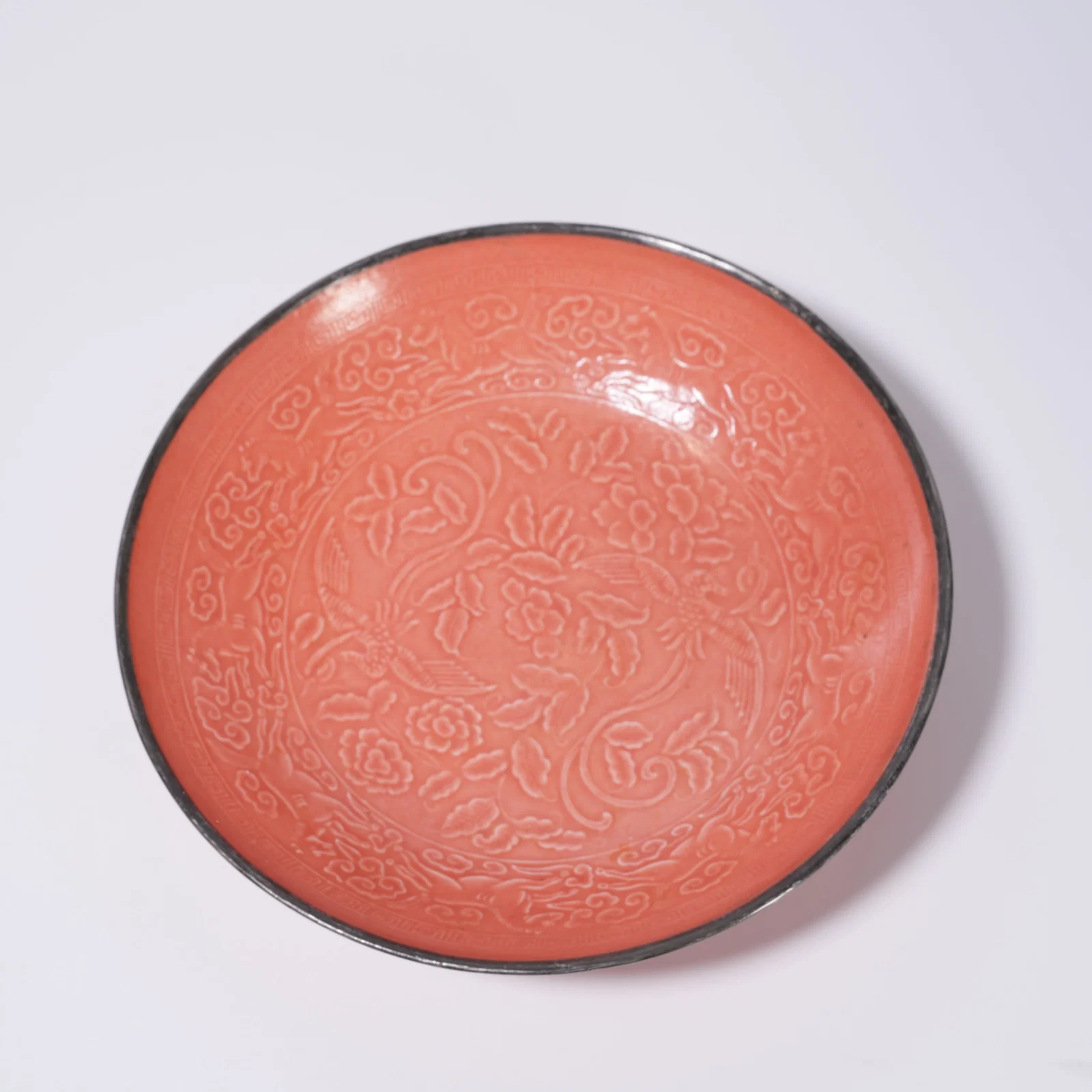 A RED-GLAZED DISH WITH BIRD-AND-FLOWER DESIGN