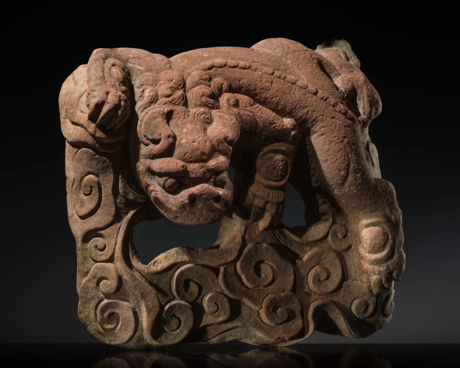 A RED SANDSTONE OPENWORK STELE WITH A GUARDIAN LION, MING DYNASTY