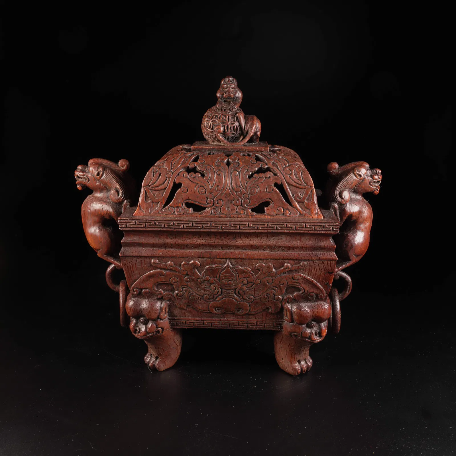 A REDWOOD INCENSE BURNER WITH BEAST HANDLES