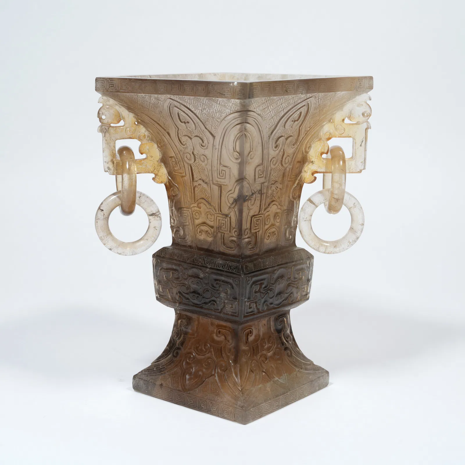 A ROCK CRYSTAL CARVED GU-FORM VASE WITH BEAST-MASK MOTIFS