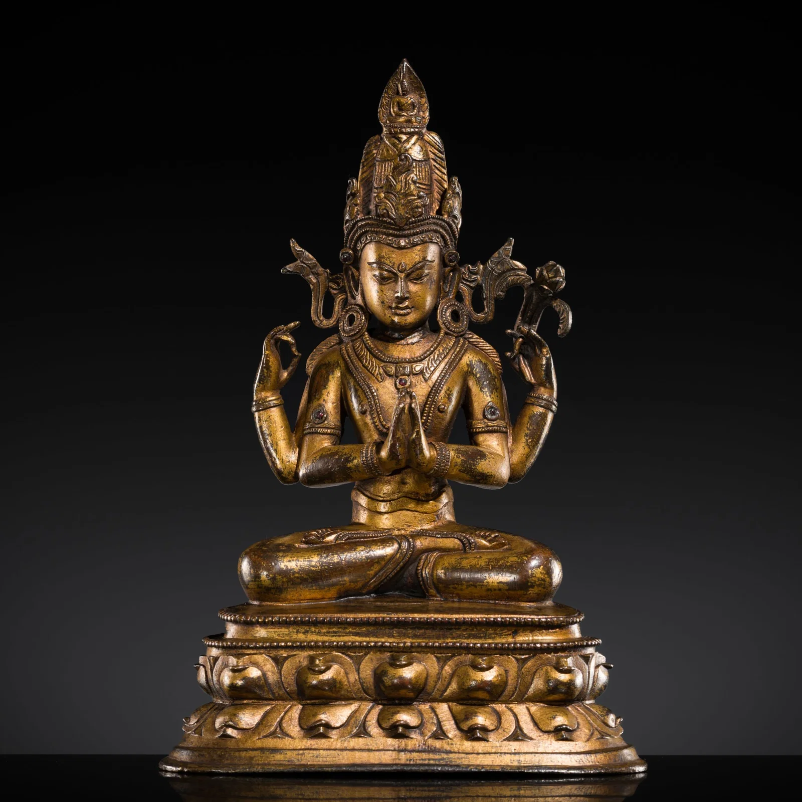 A RUBY-INLAID GILT-BRONZE FIGURE OF SHADAKSHARI LOKESHVARA, WESTERN TIBET, 14TH CENTURY
