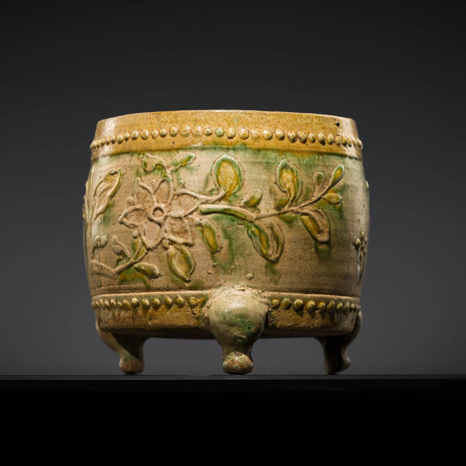 A SANCAI-GLAZED DRUM-FORM 'PEONY' TRIPOD CENSER, LIAO DYNASTY (916-1125)