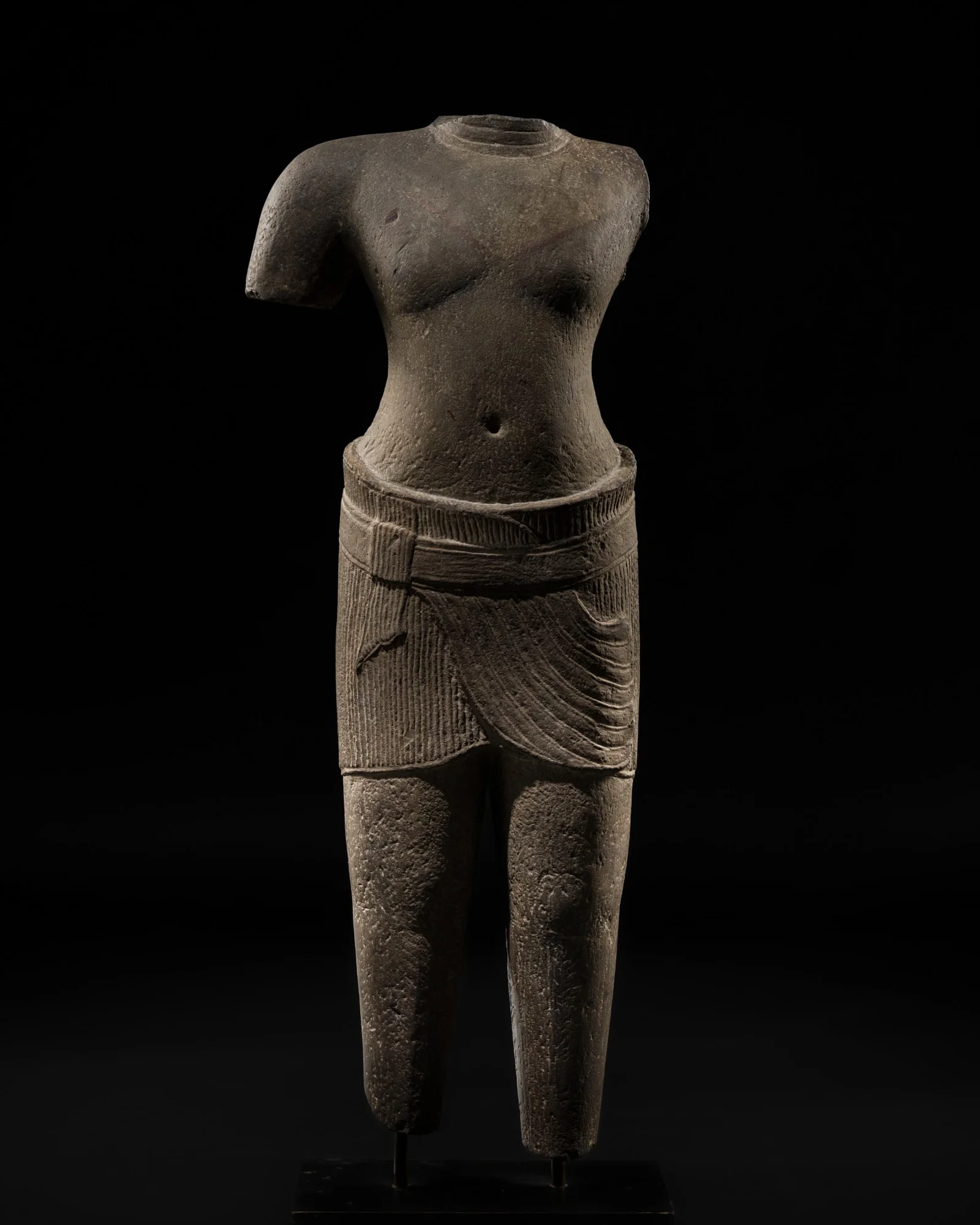 A SANDSTONE FIGURE OF A MALE DEITY, ANGKOR PERIOD, ANGKOR WAT STYLE, 12TH CENTURY