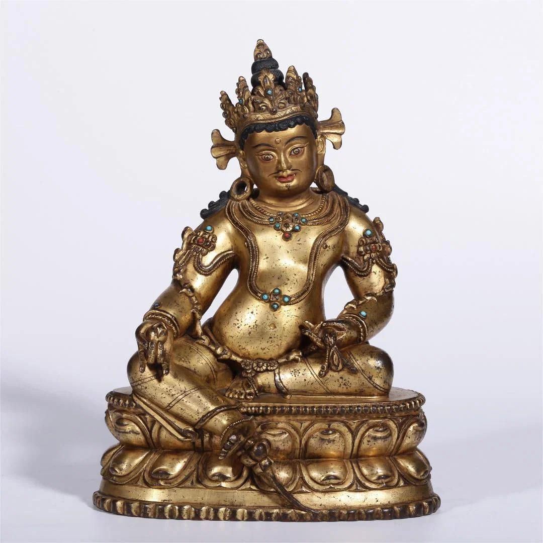 A seated statue of the God of Wealth in copper gilt gold from the Qing Dynasty