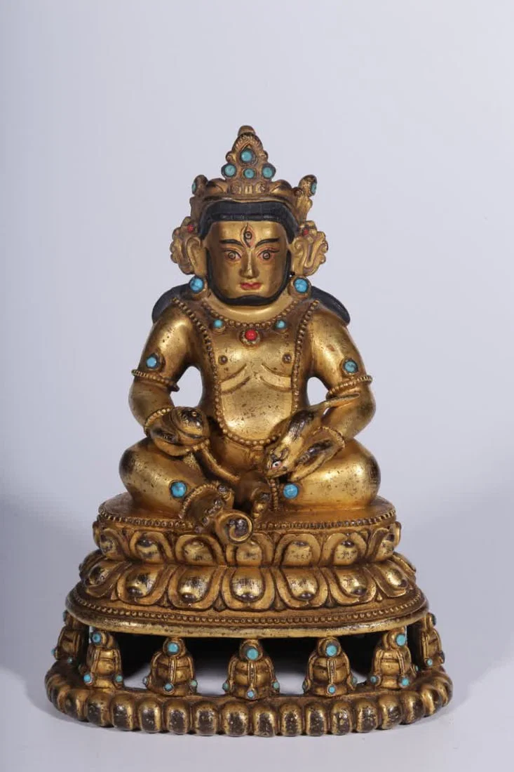 A seated statue of the God of Wealth in the Qing Dynasty with copper gilt inlaid treasures