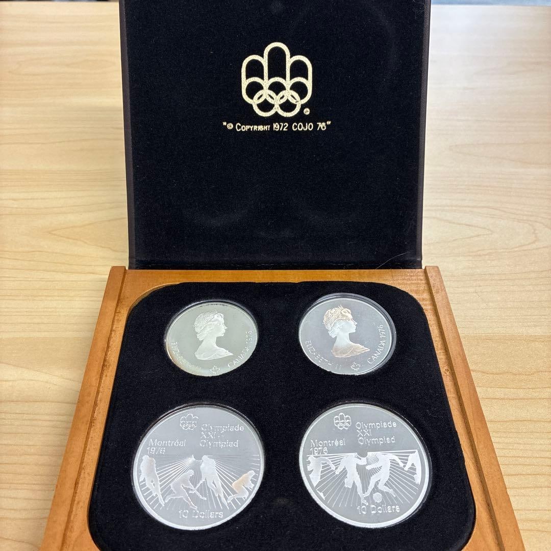 A set of 4 commemorative silver coins from the 1976 Montreal Olympics.