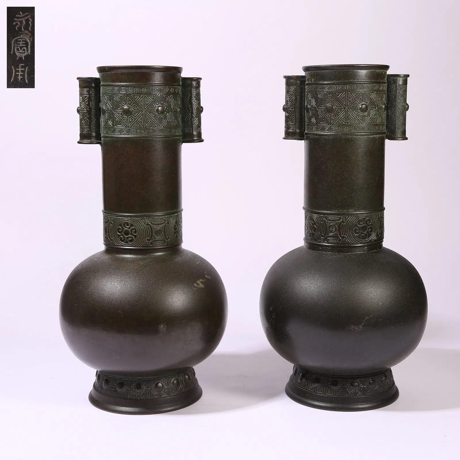 A SET OF BRONZE FLAT-HANDLED VASES