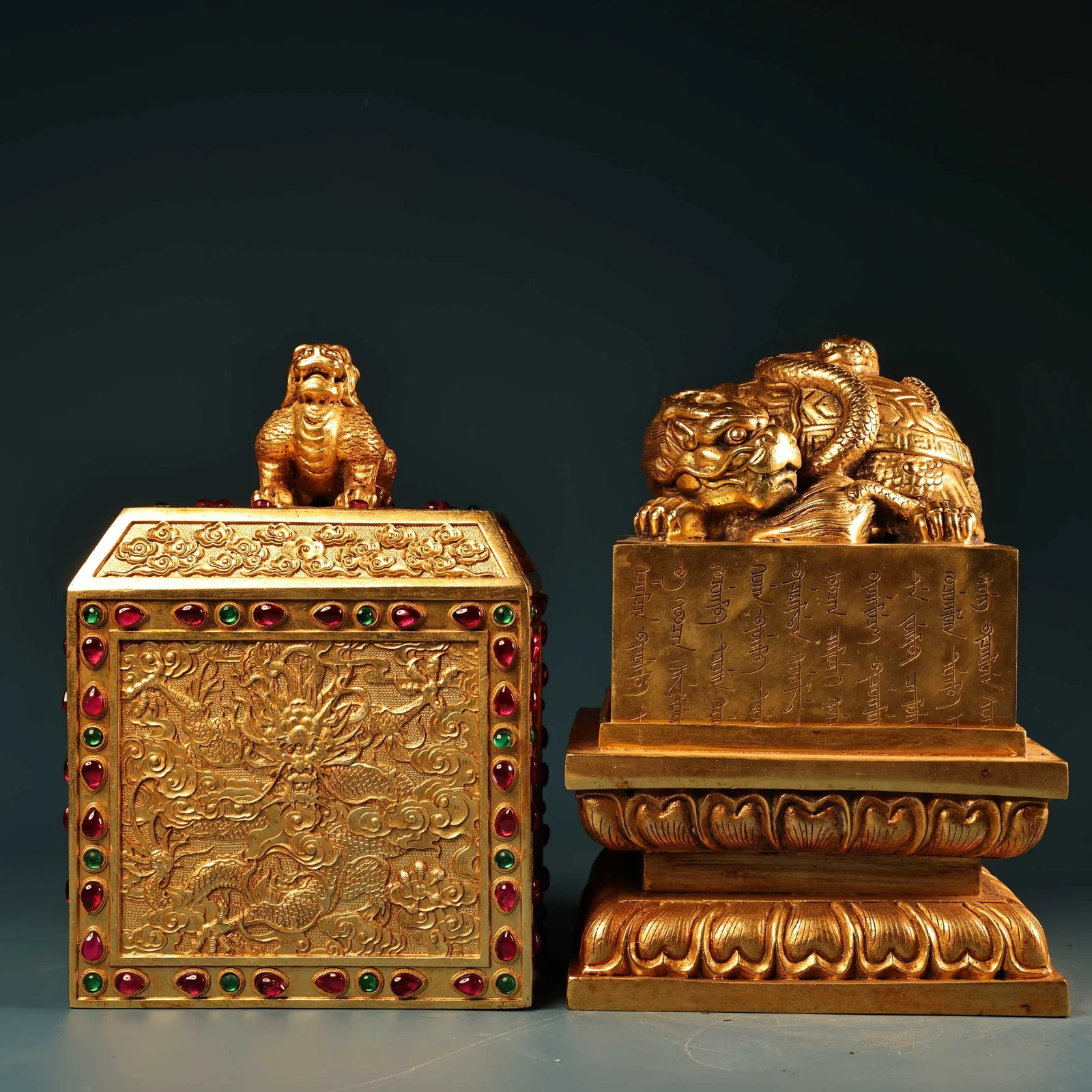 A set of rare, high-relief engraved gold-plated seals in a box.