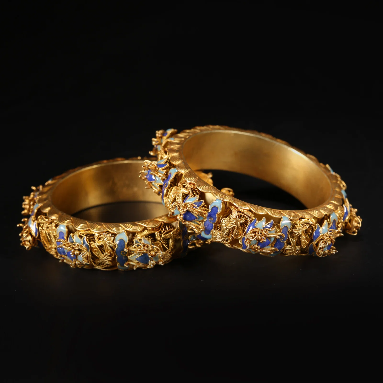 A SET OF SILVER GILT, FIRE-BLUE DRAGON MOTIF BRACELETS