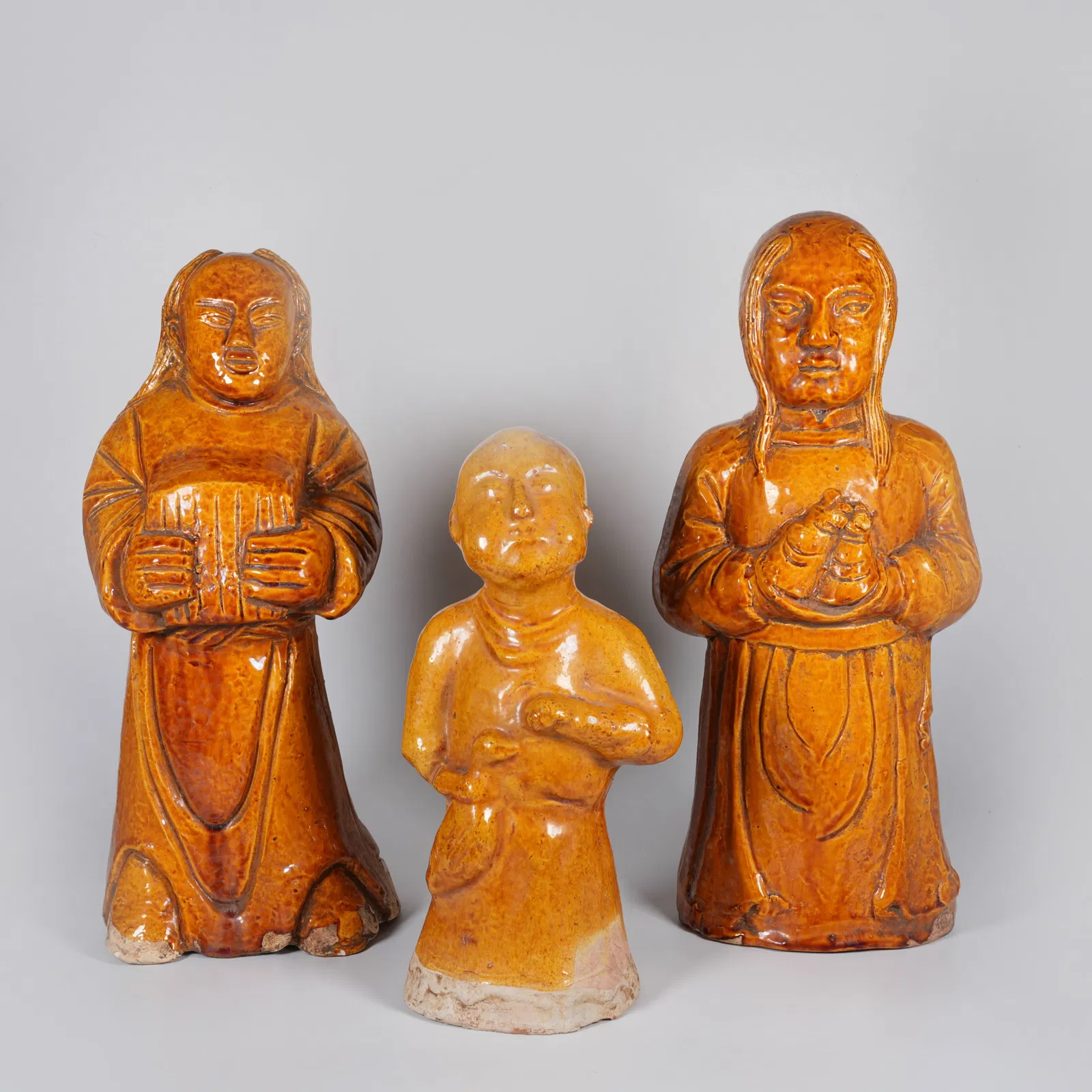 A SET OF YELLOW-GLAZED FIGURINES