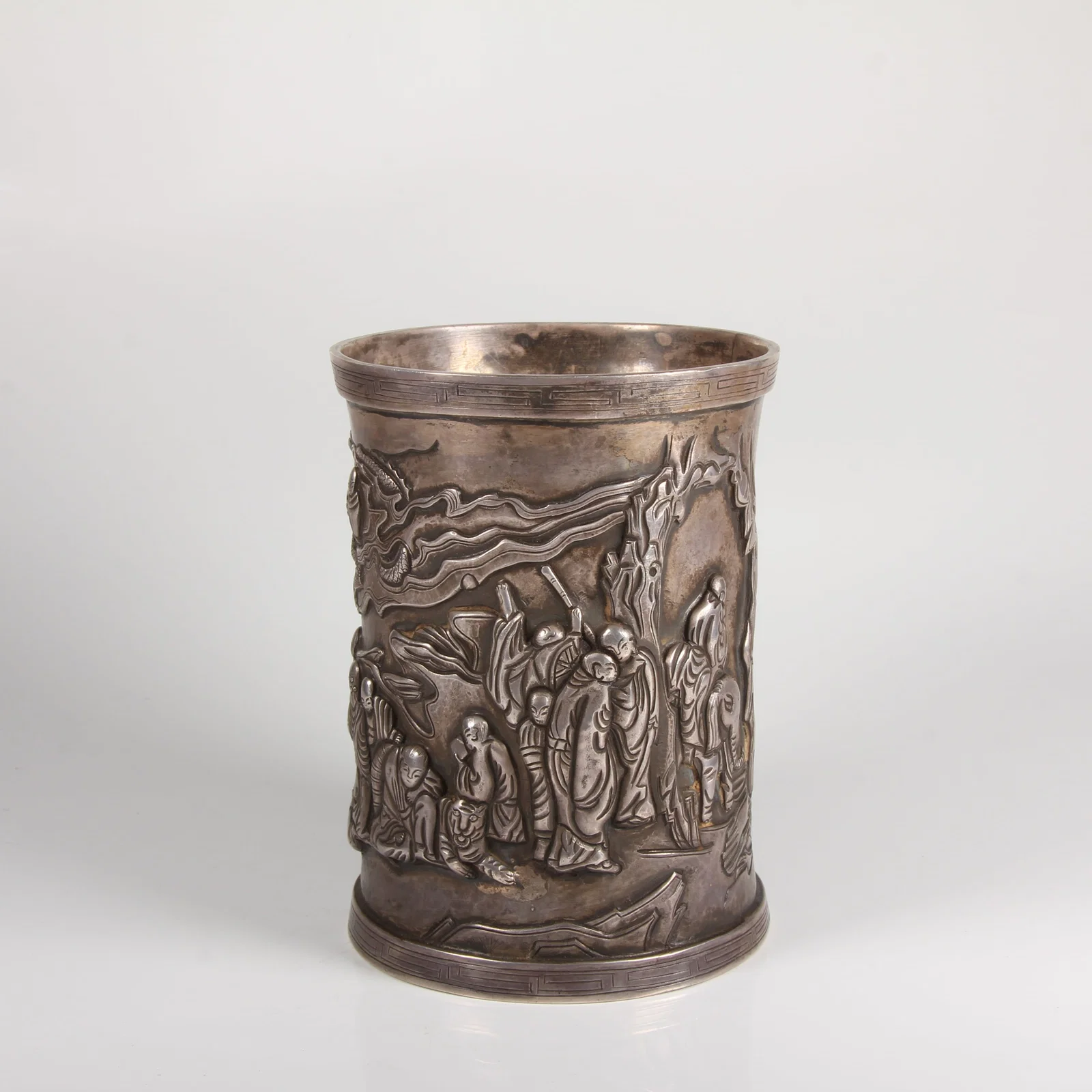 A SILVER BRUSH POT WITH EIGHTEEN ARHATS MOTIF