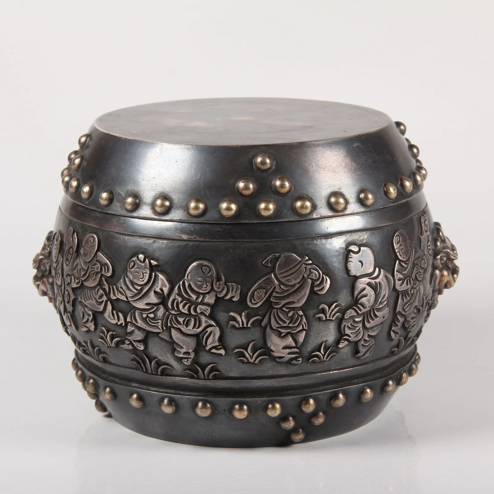 A SILVER DRUM-SHAPED WINE WARMER WITH BABY PLAY MOTIF