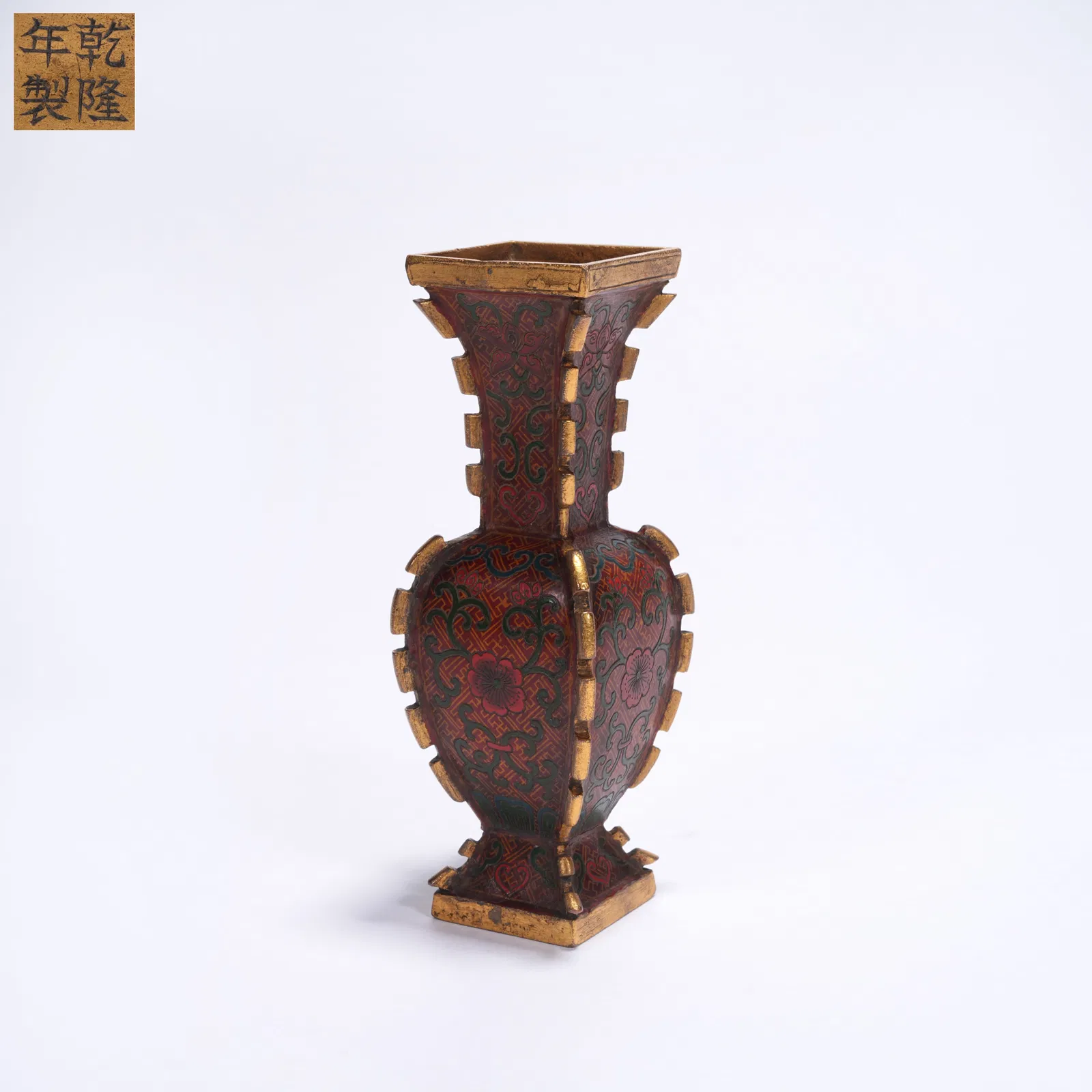 A SMALL BRONZE GU VASE WITH GILT AND POLYCHROME DECORATION AND FLANGED RIDGES