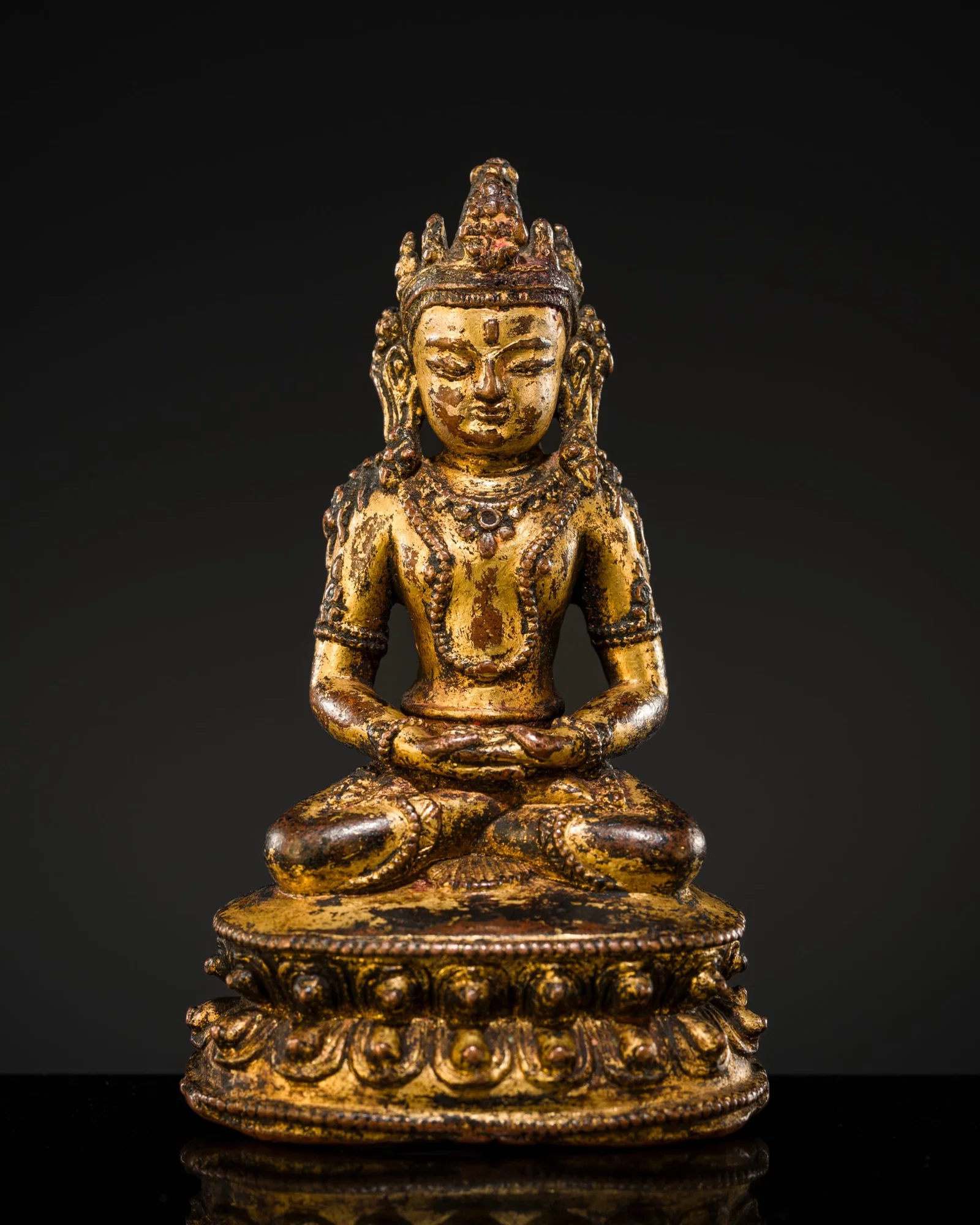 A SMALL GILT COPPER-ALLOY FIGURE OF AMITAYUS, NEPAL, 14TH-15TH CENTURY