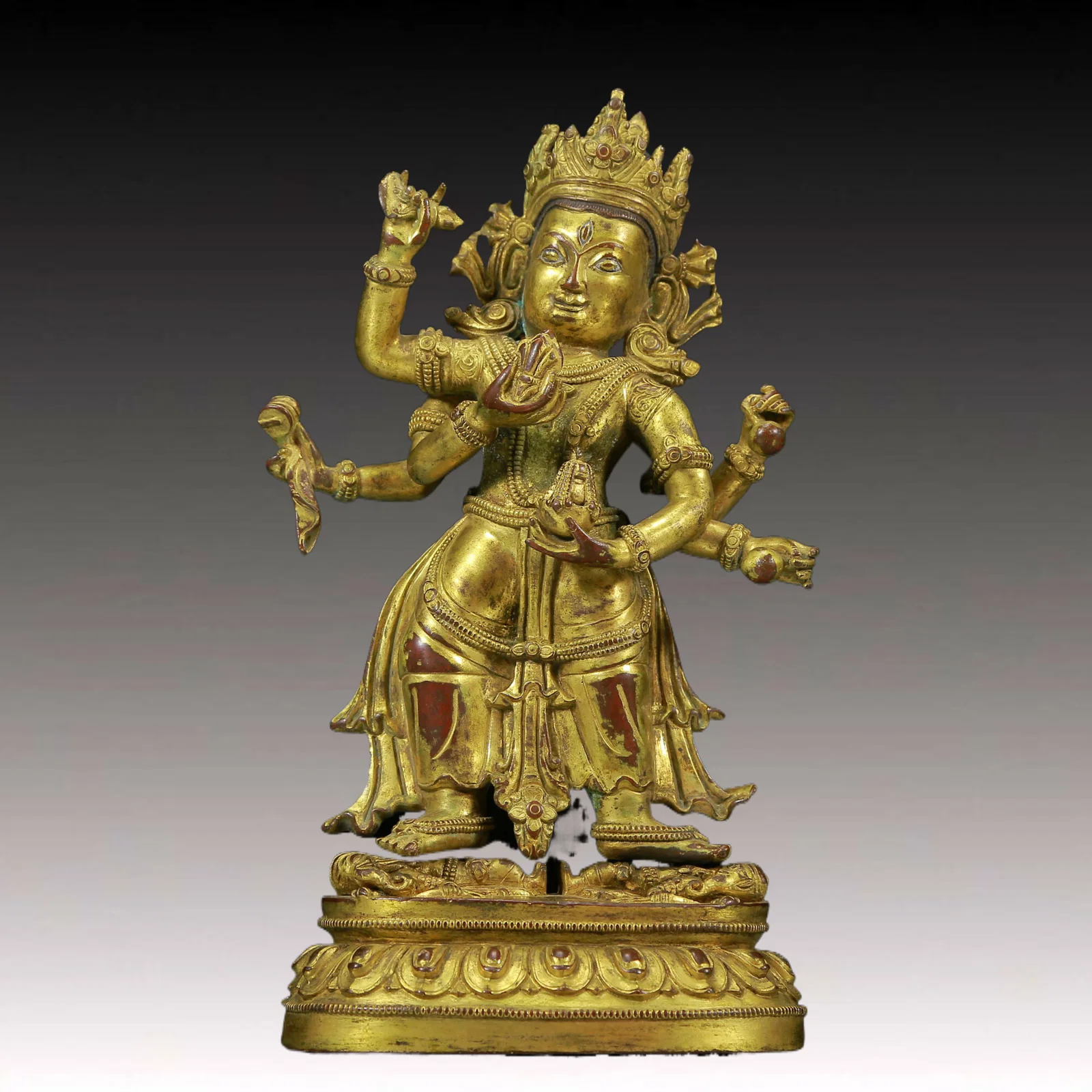 A Solemn Gilt Bronze Six-Armed Buddha