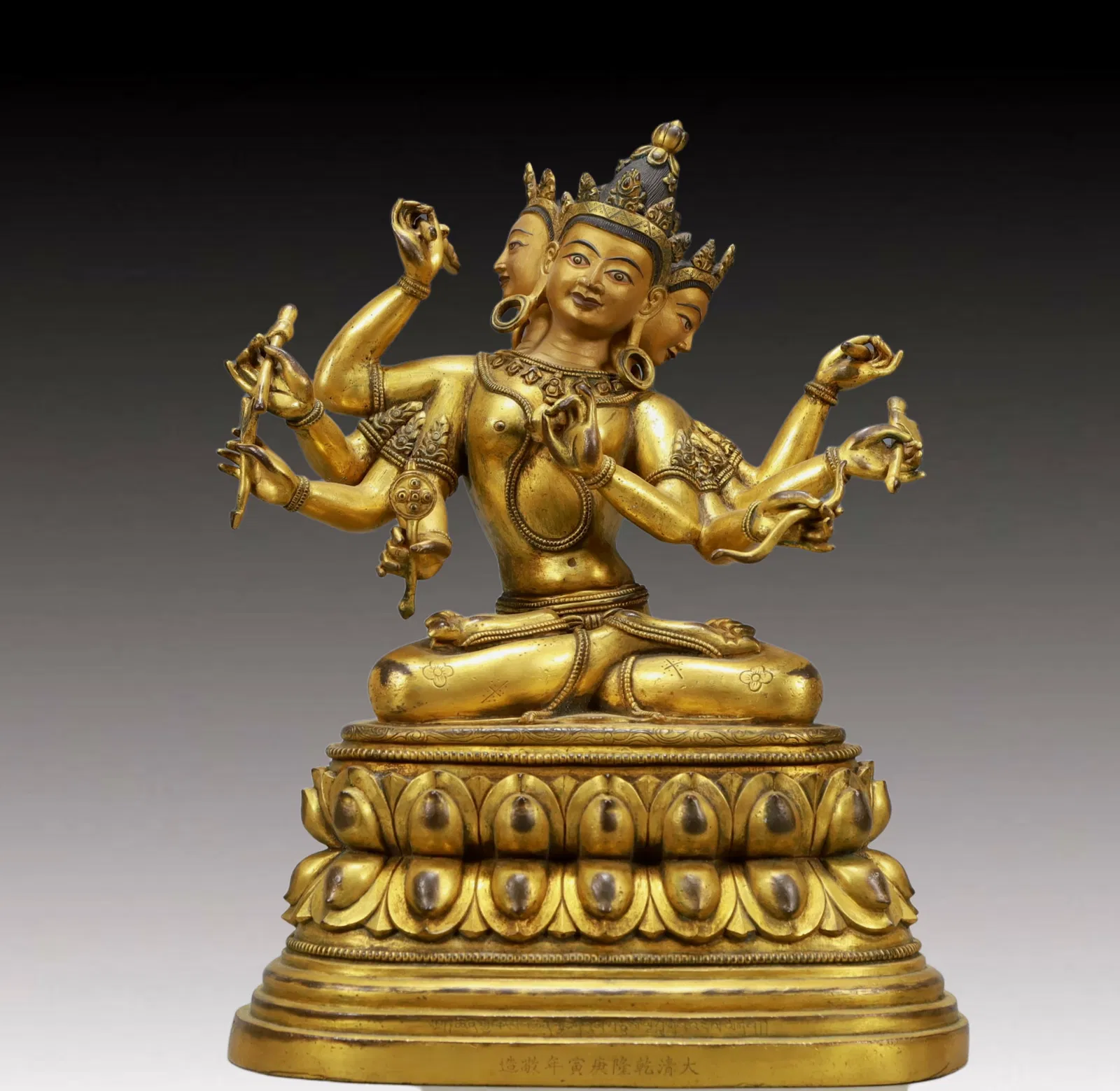 A Solemn Gilt Bronze Statue of Three-Headed and Eight-Armed Guanyin