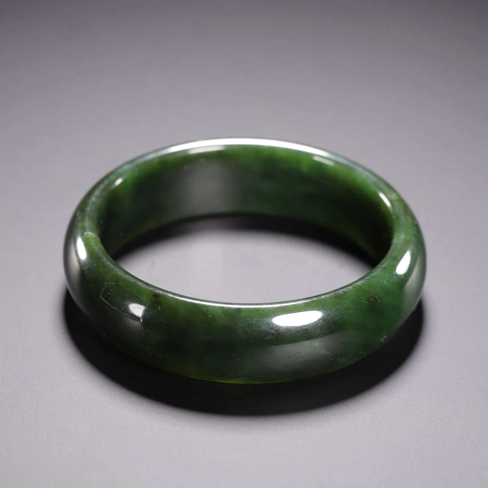 A SPINACH GREEN JADE BANGLE