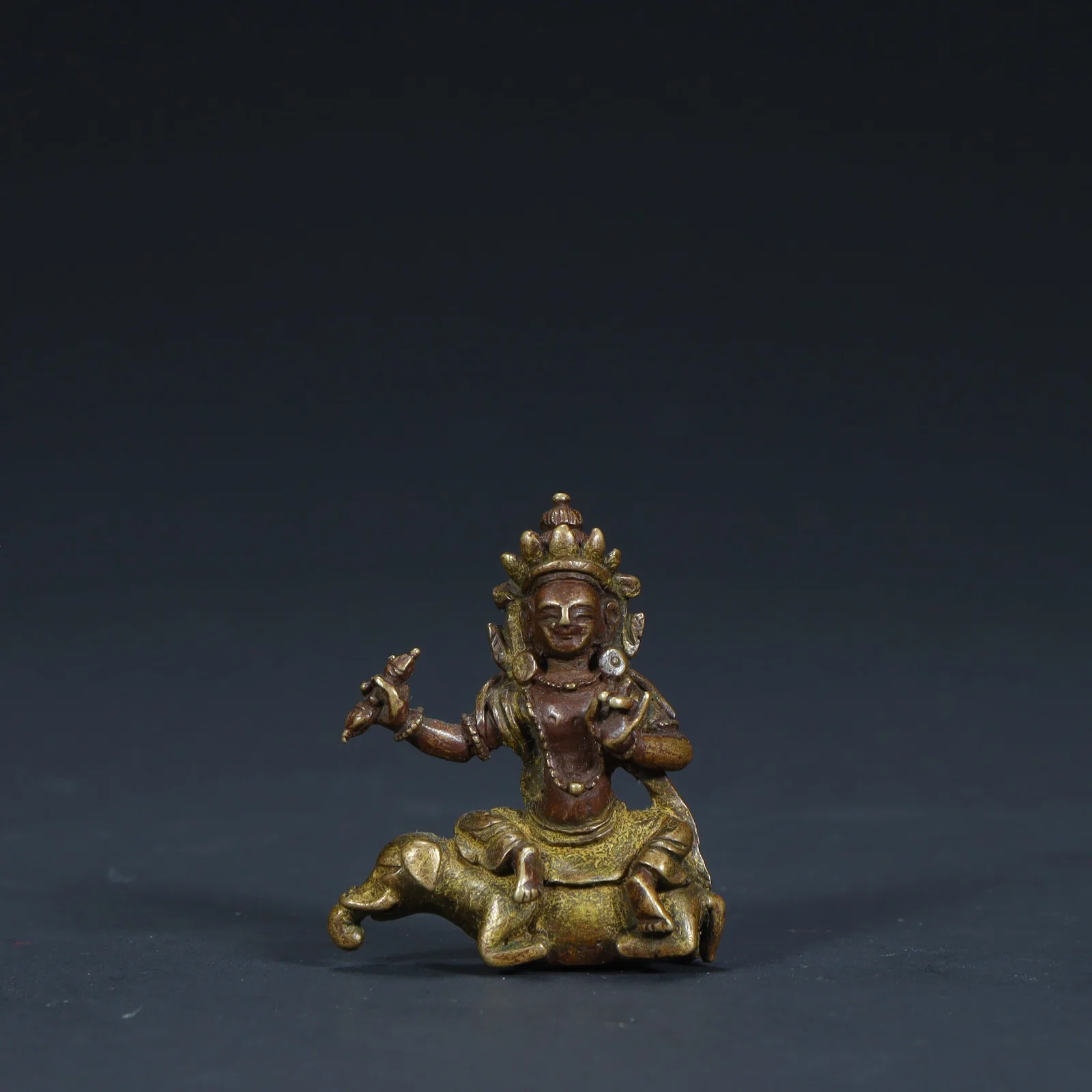 A statue of the Qing Dynasty bronze clay golden riding elephant yellow God of Wealth