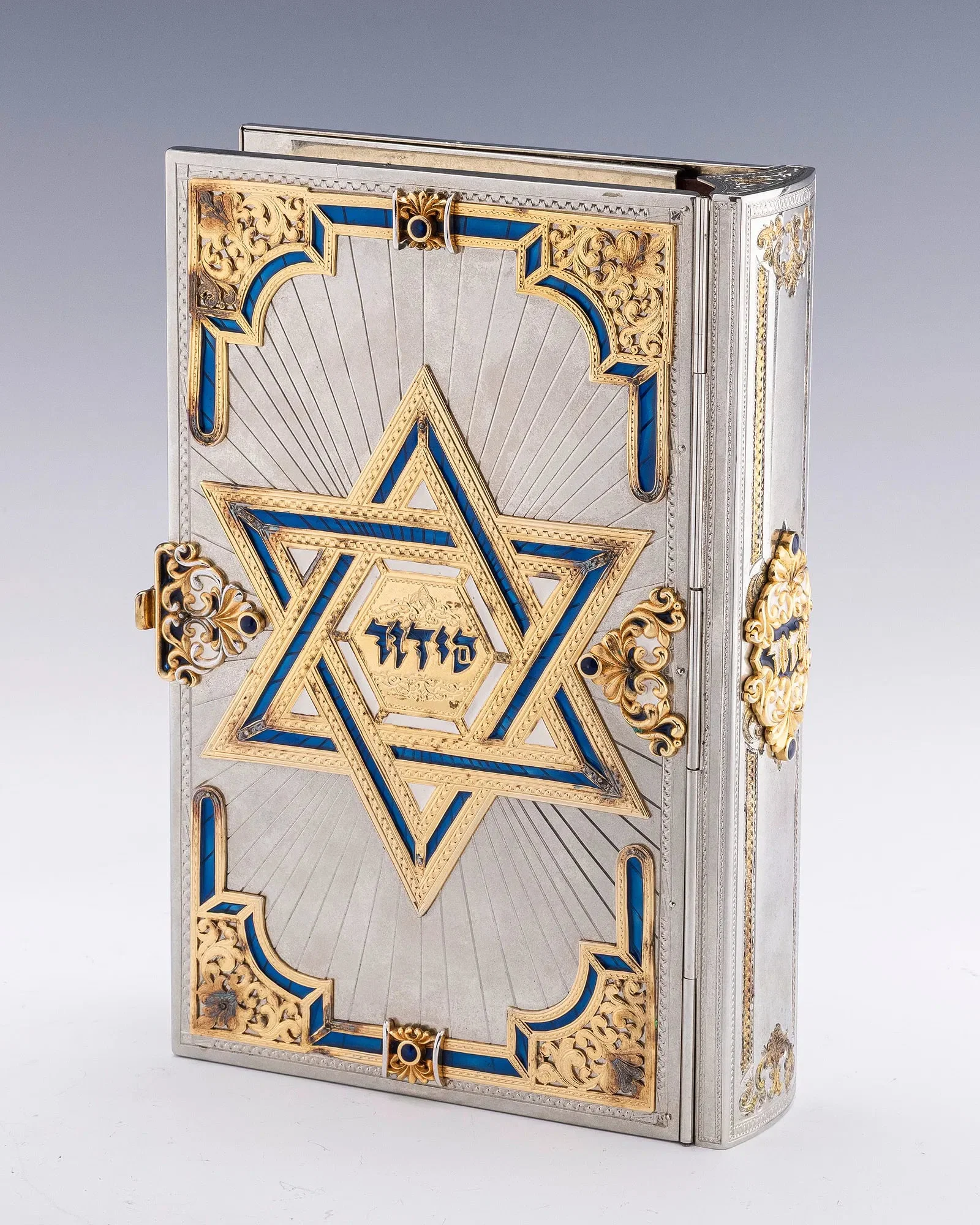 A STERLING SILVER, ENAMEL AND GILDED IDF SIDDUR BINDING BY YAAKOV DAVIDOFF.