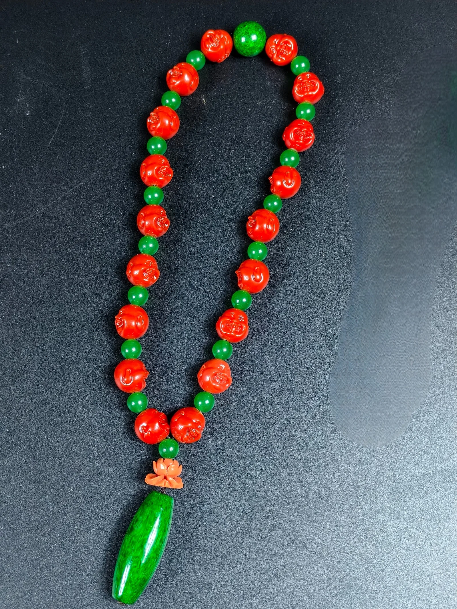 A string of coral Maitreya Buddha prayer beads