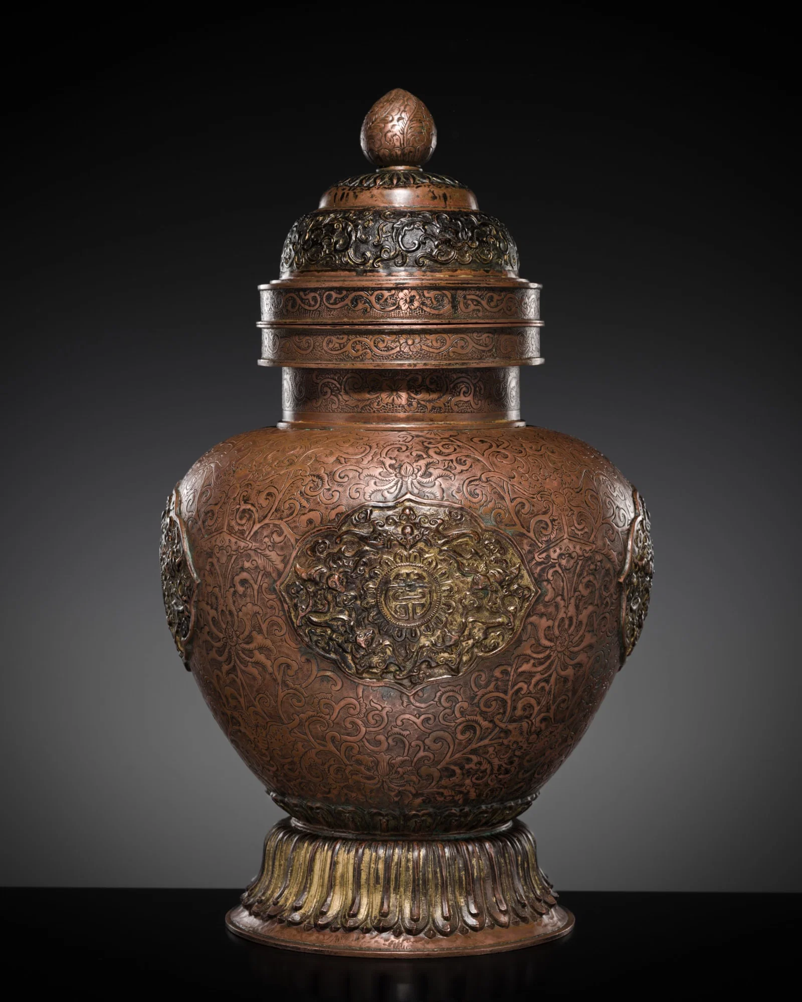 A TIBETAN-CHINESE PARCEL-GILT COPPER REPOUSSÉ JAR AND COVER, 19TH CENTURY