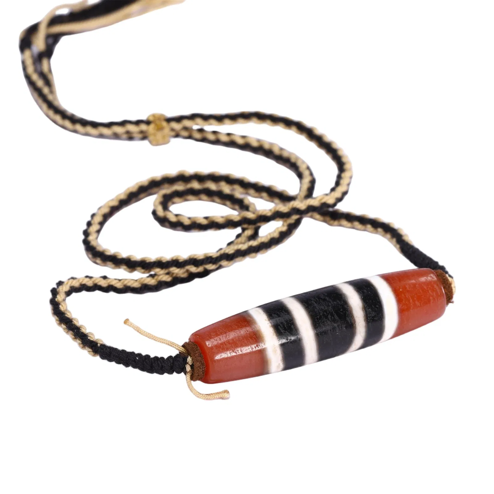 A TIBETAN DZI BEAD PENDANT