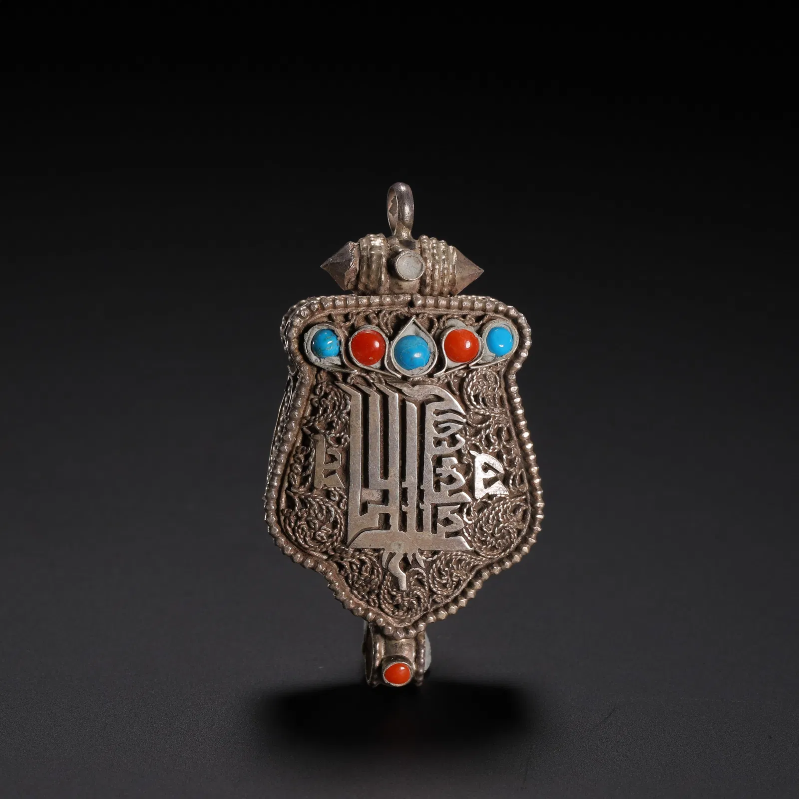 A TIBETAN SILVER AMULET PENDANT