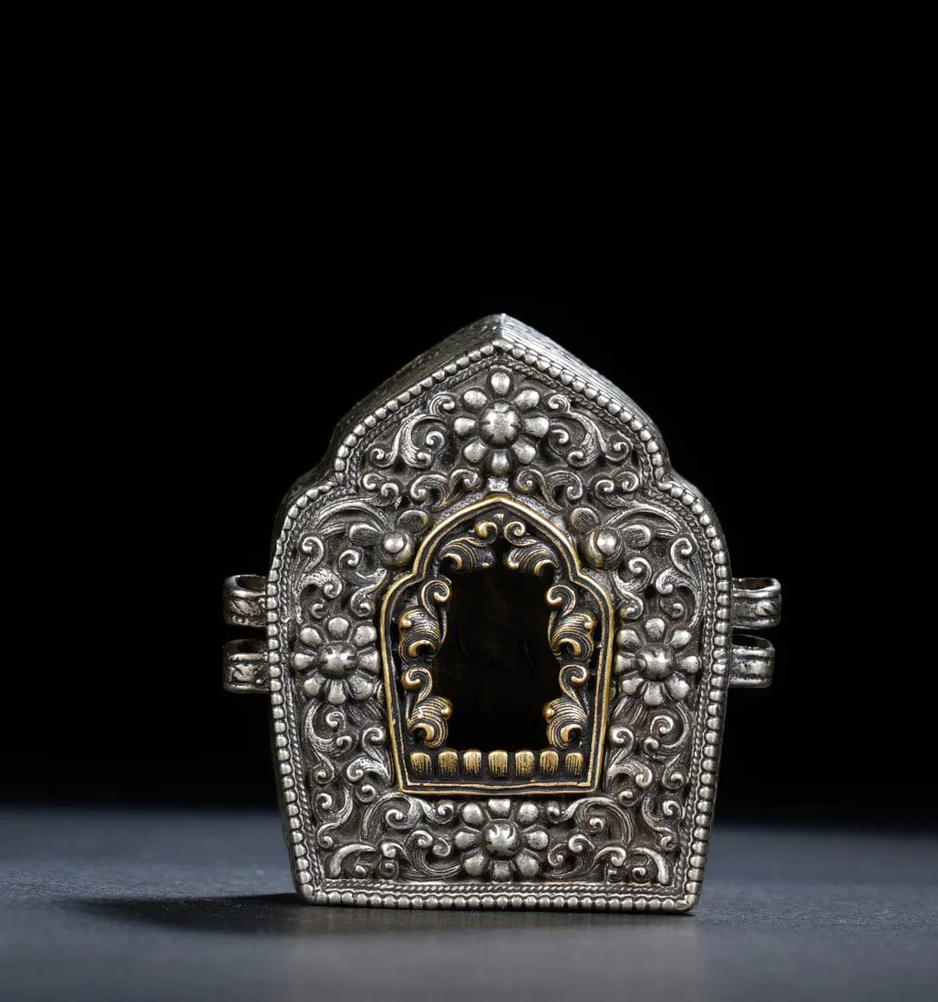 A TIBETAN SILVER PORTABLE SHRINE GAU