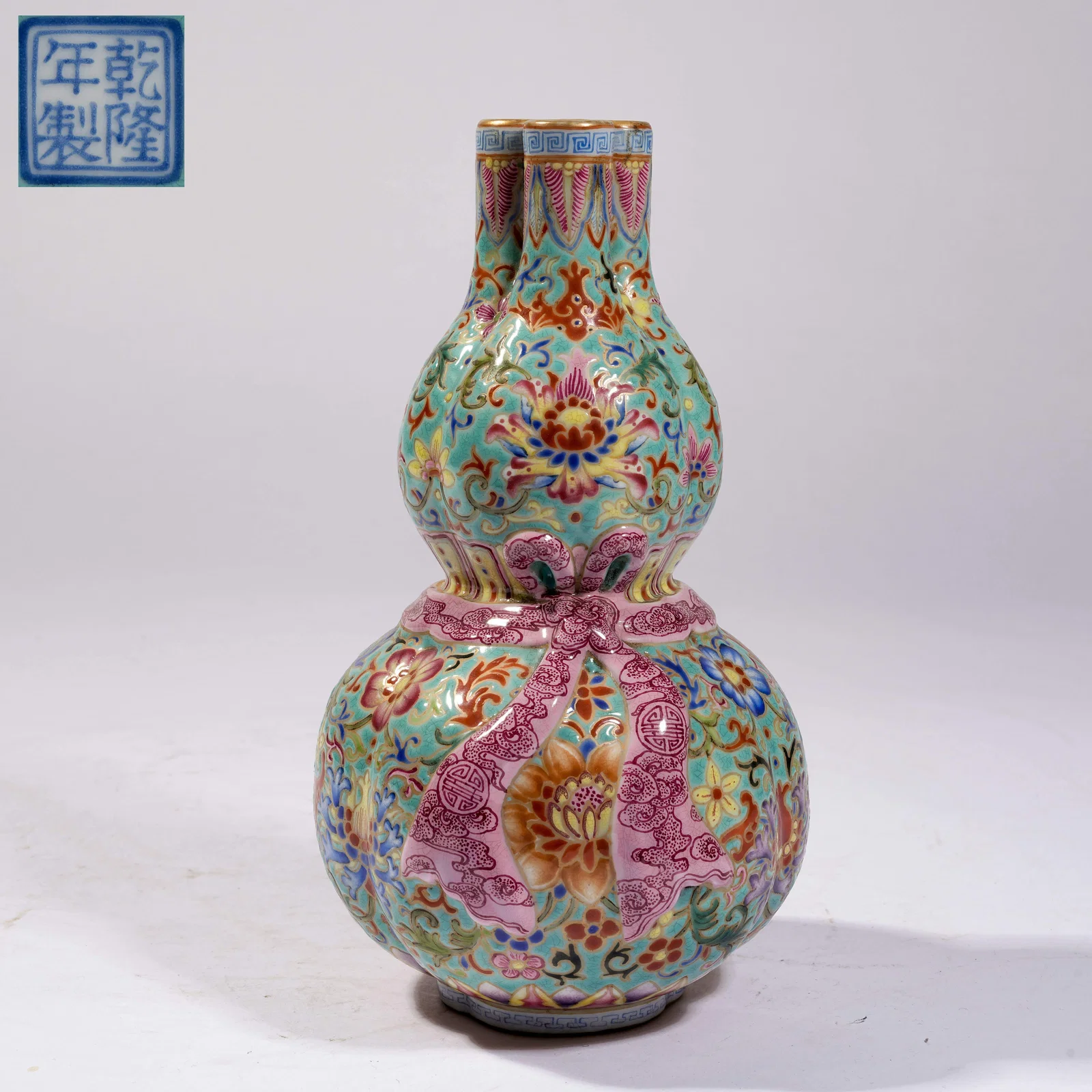 A TURQUOISE-GREEN GROUND FAMILLE ROSE MONK'S HAT TEAPOT WITH BUDDHIST EMBLEM MOTIF, THREE-HOLE GOURD