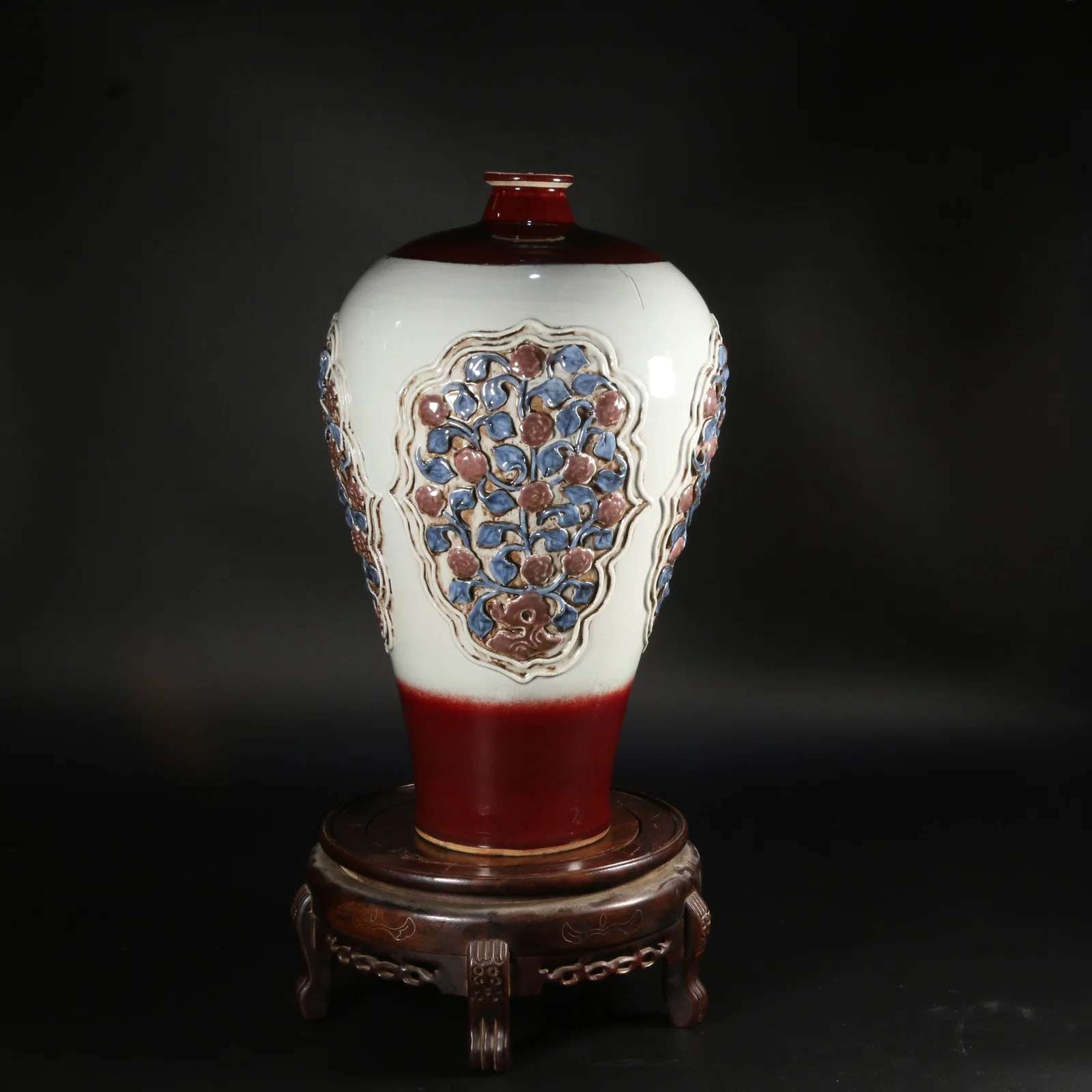 A UNDERGLAZE RED AND BLUE-AND-WHITE PRUNUS VASE WITH FOUR-WINDOW FLORAL RELIEF DECORATION