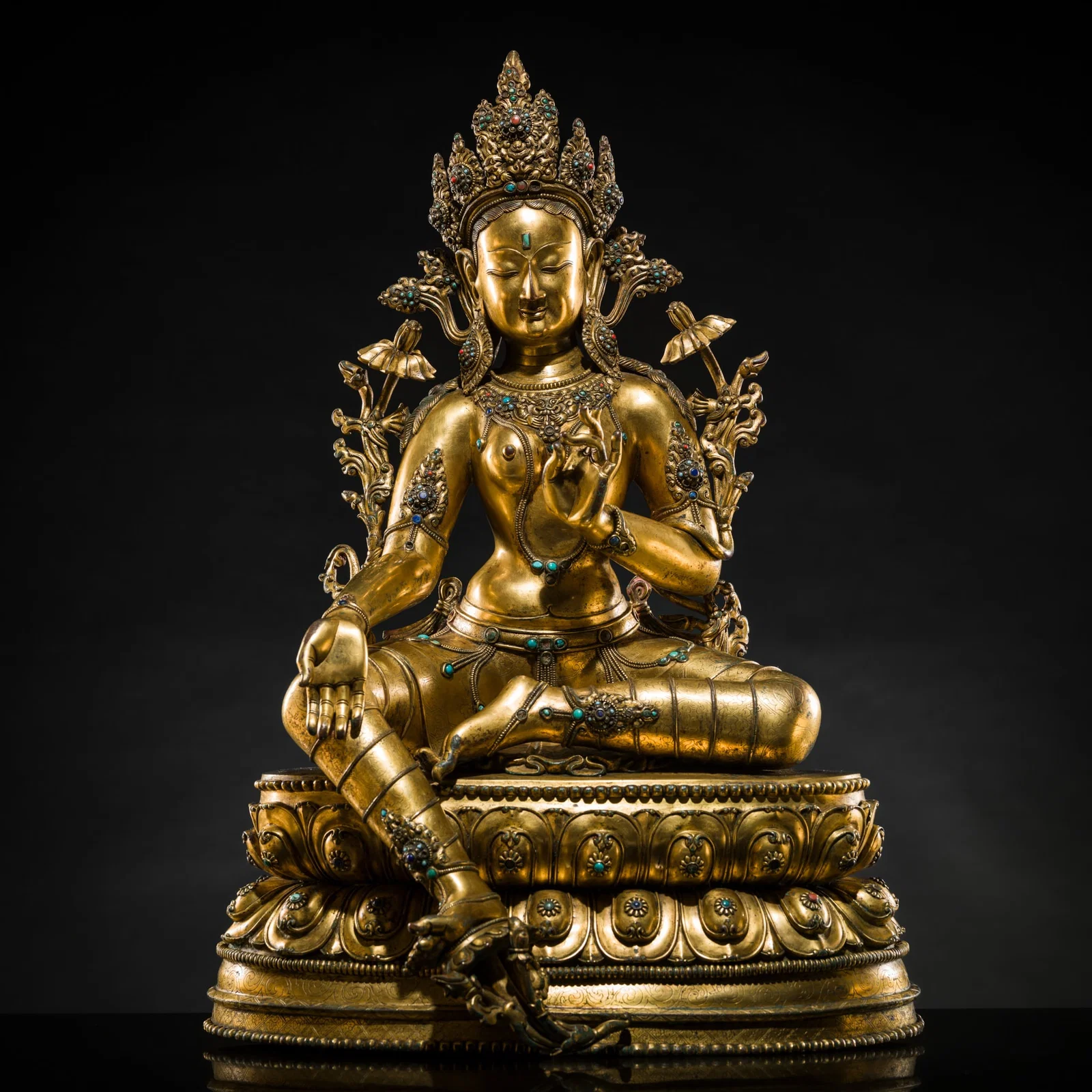 A VERY LARGE AND EXCEPTIONALLY RARE GILT-BRONZE FIGURE OF GREEN TARA, TIBET, CIRCA 16TH-18TH CENTURY