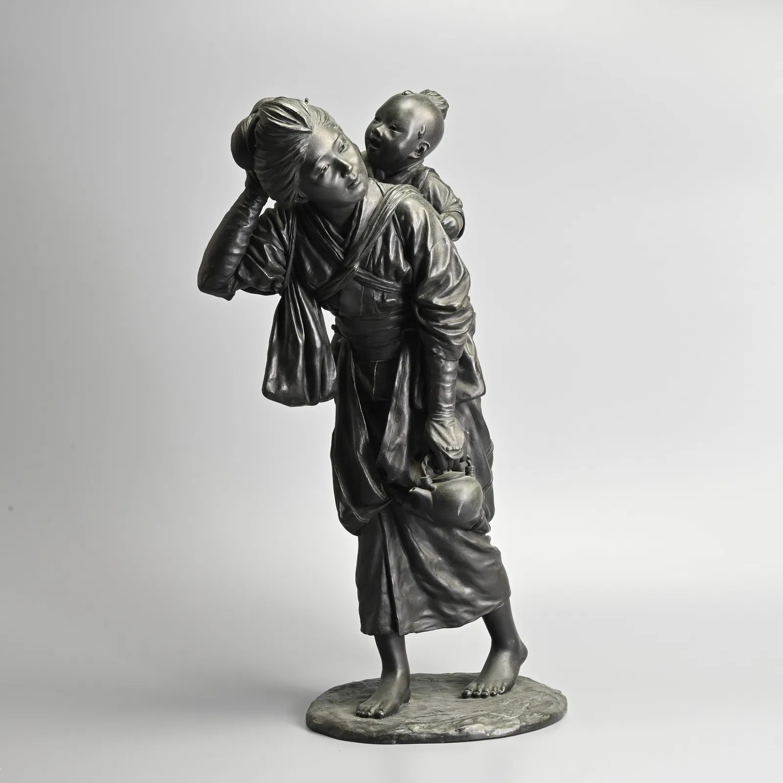 A VERY LARGE JAPANESE BRONZE GROUP OF A MOTHER AND CHILD, TOKYO SCHOOL, 20TH CENTURY.
