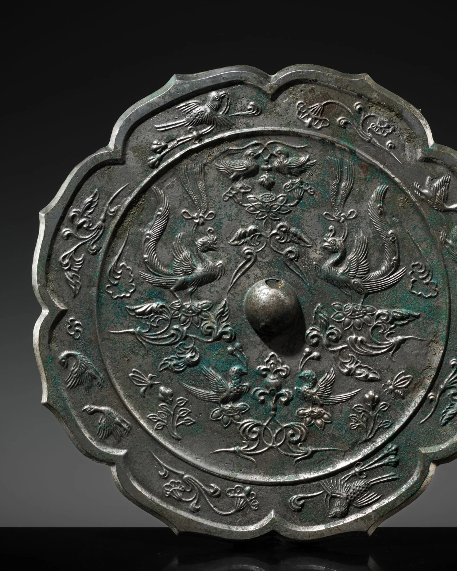 A VERY LARGE SILVERED 'PHOENIX AND BIRDS' OCTAFOIL BRONZE MIRROR, TANG DYNASTY