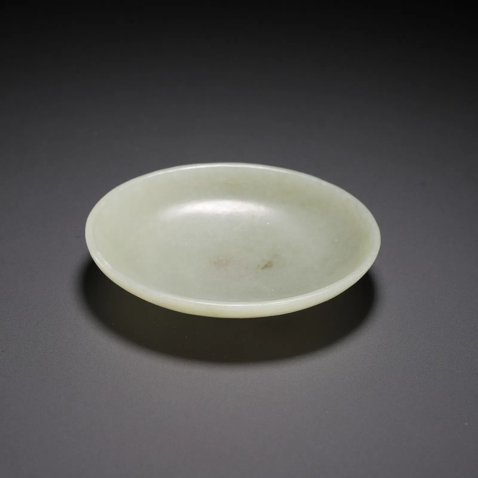 A WHITE JADE SAUCER