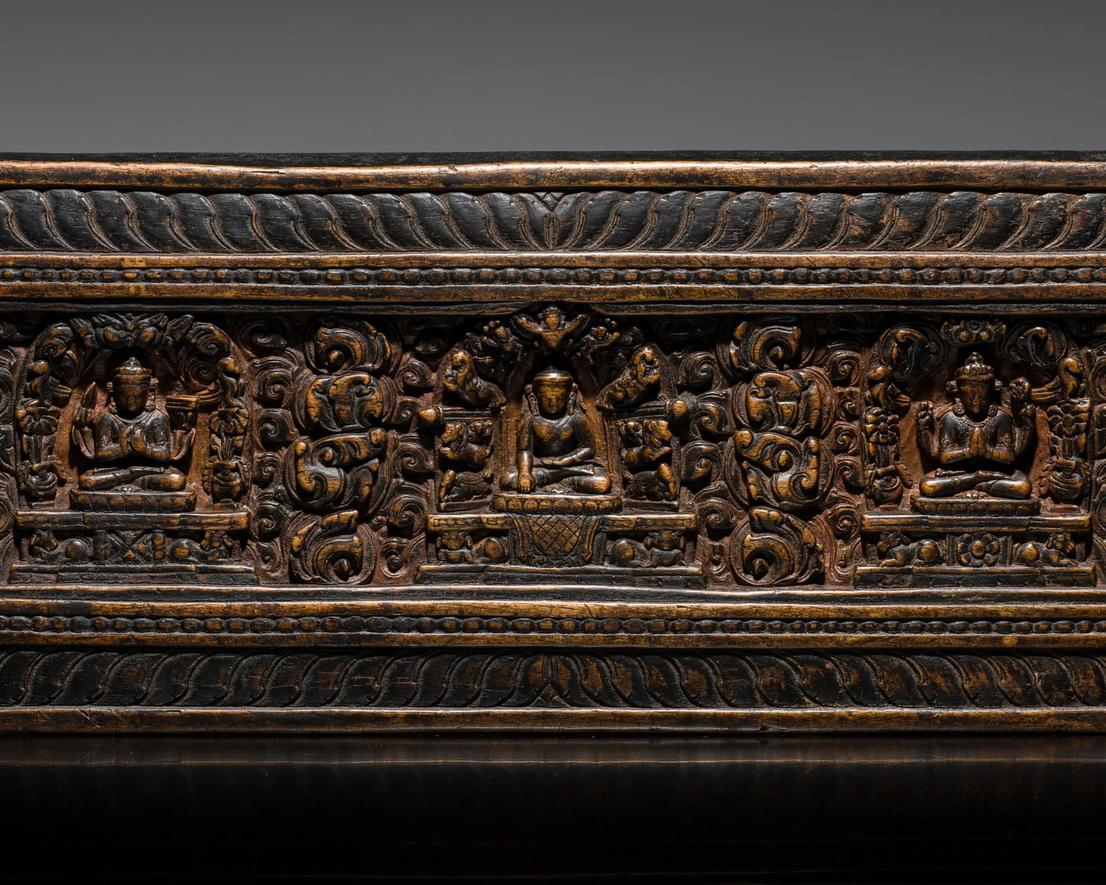 A WOOD MANUSCRIPT COVER WITH BUDDHA, SHADAKSHARI, AND PRAJNAPARAMITA, TIBET, 14TH-15TH CENTURY