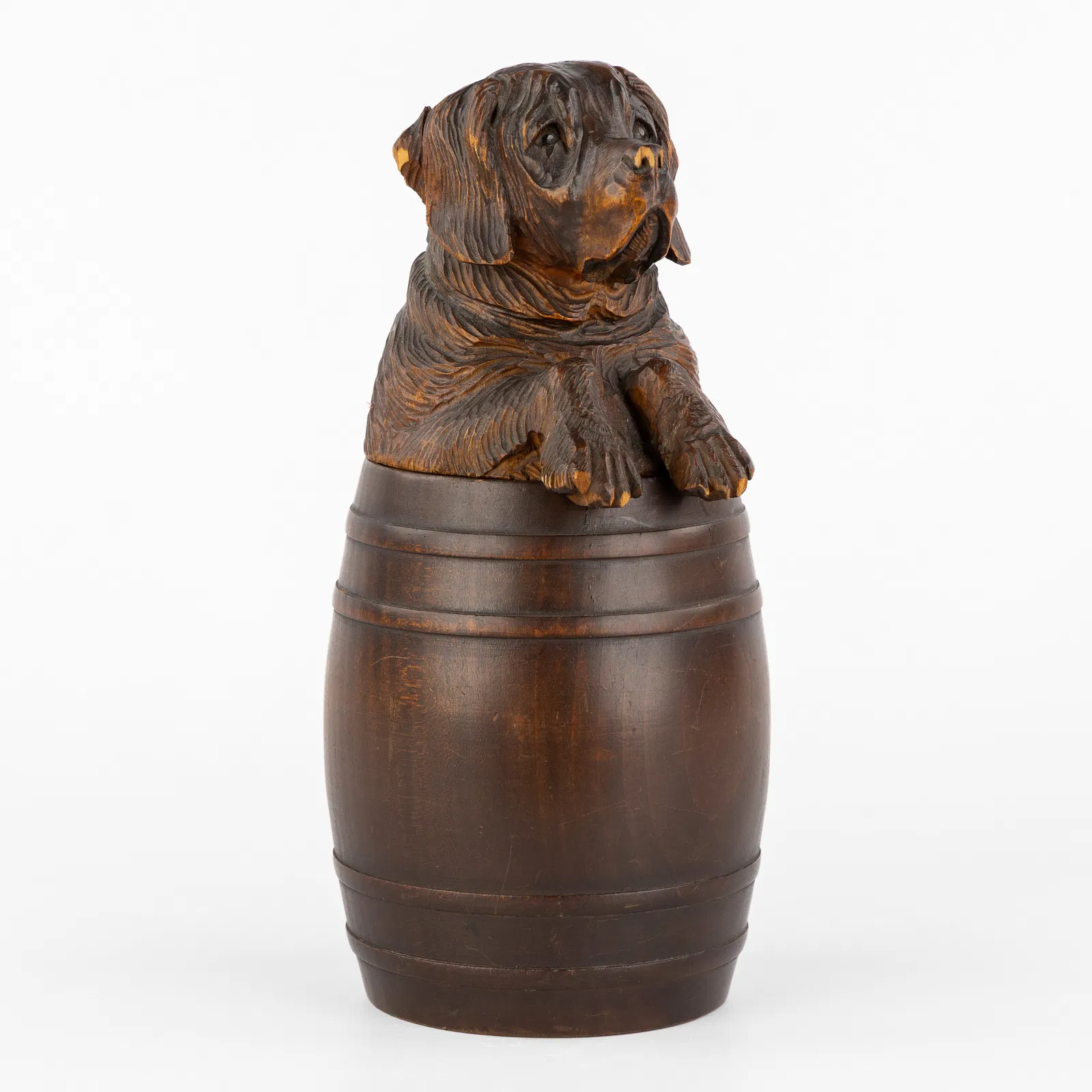 A Wood-sculptured Lidded Jar, Saint Bernard dog in a Brandy barrel, Black Forest, Switzerland,